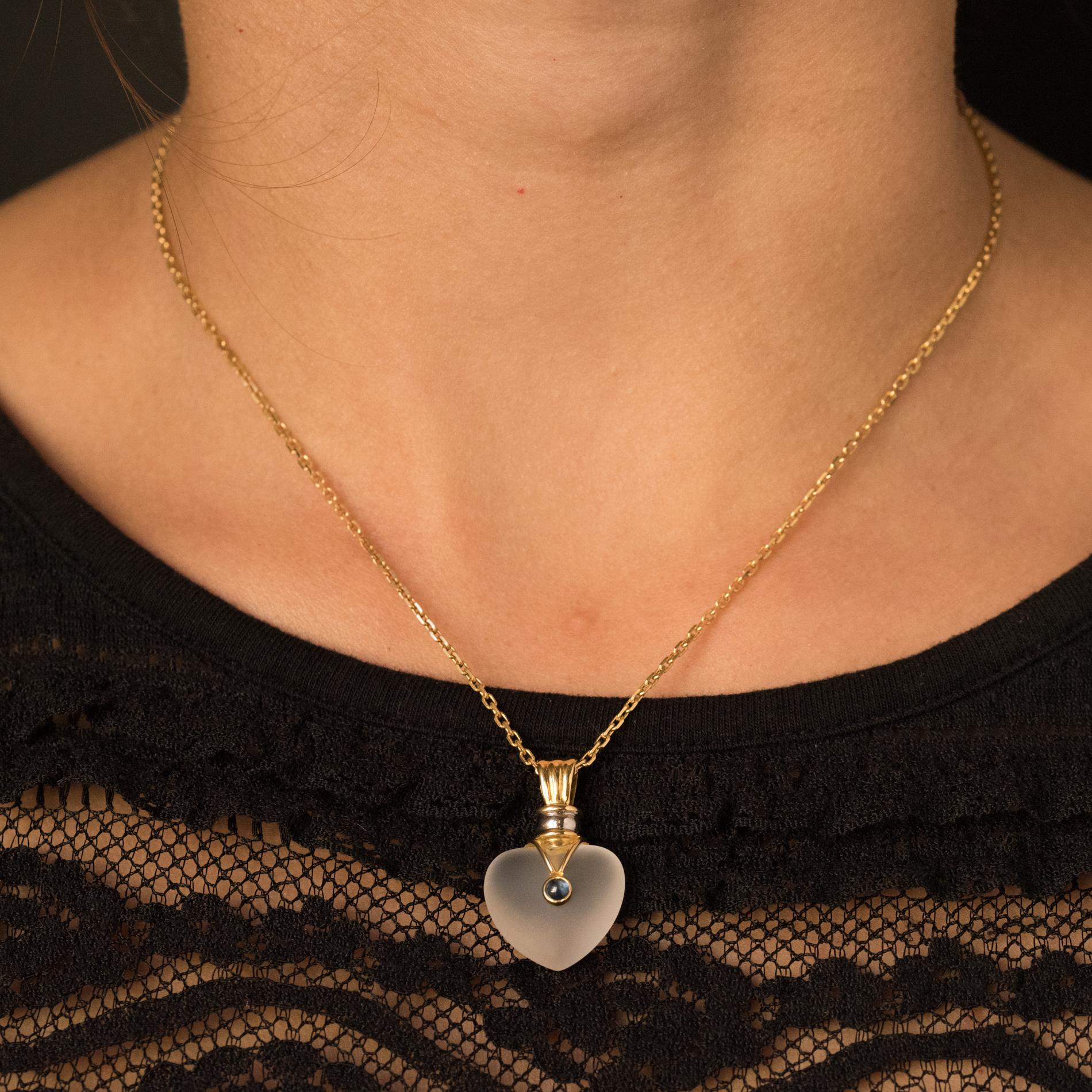 Pendant in 18 karats yellow gold, eagle's head hallmark.
It consists of a crystal heart set in the center of a cabochon blue stone. The bail is in 2 colors of gold, white and yellow. The chain bas a spring ring.
Dimensions of the pendant: Height: