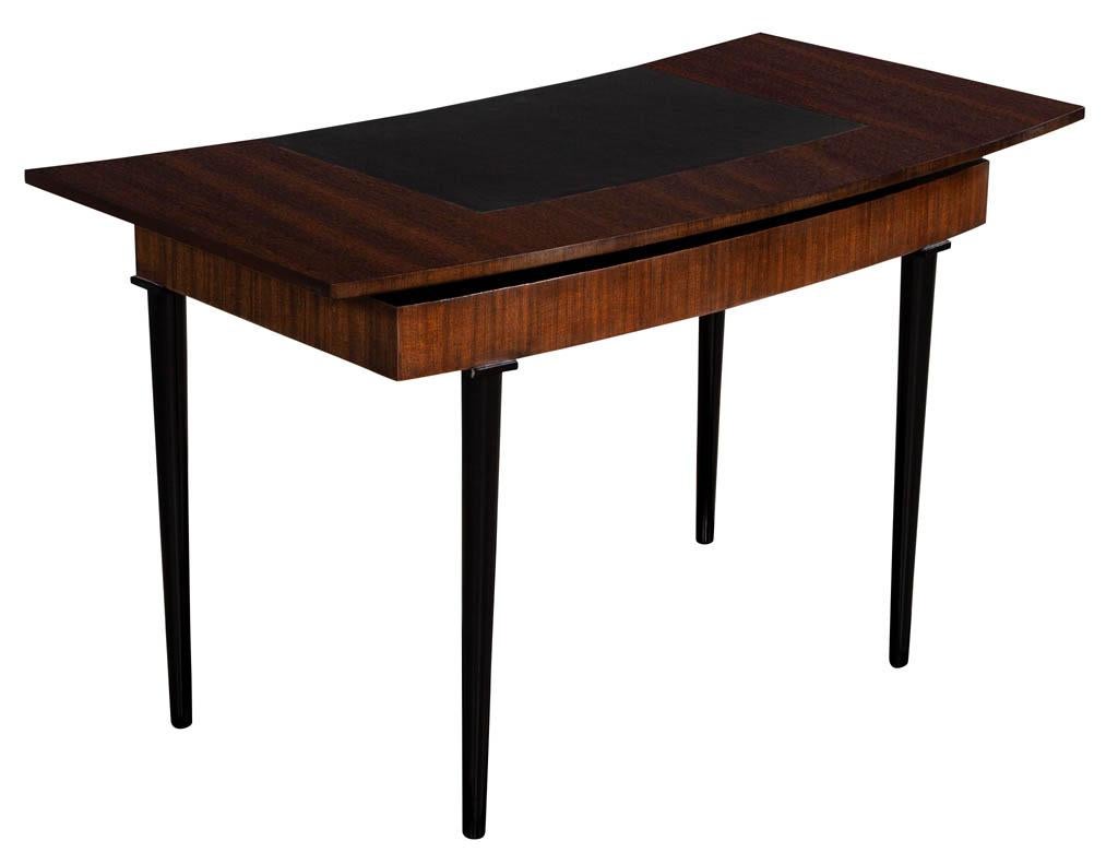 Modern curved mahogany writing desk. Featuring unique curved wing span design with a pencil drawer, leather top and ebonized legs.

Price includes complimentary scheduled curb side delivery service to the continental USA.