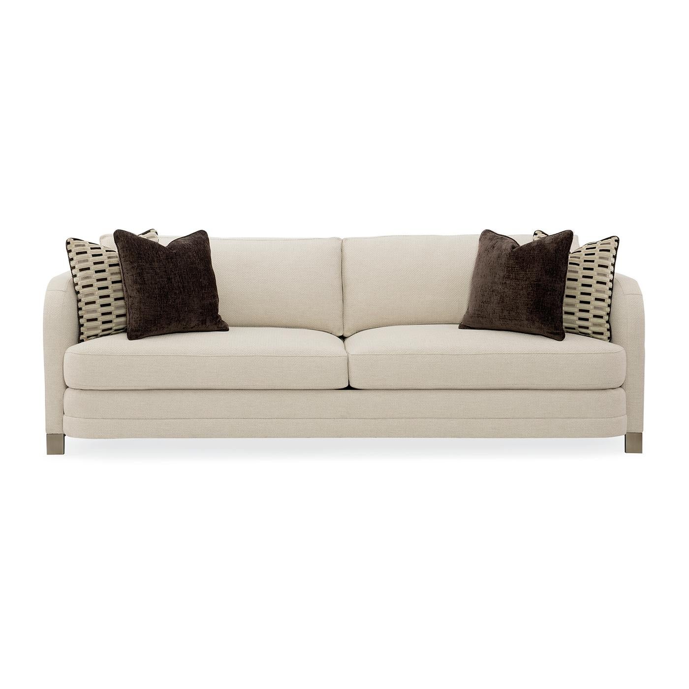 The streamlined appeal of this low, modern sofa comes from its generously curved features. The piece has a refined profile with a sophisticated rounded frame that welcomes you to sit and relax. Fully upholstered in a textured, creamy basketweave