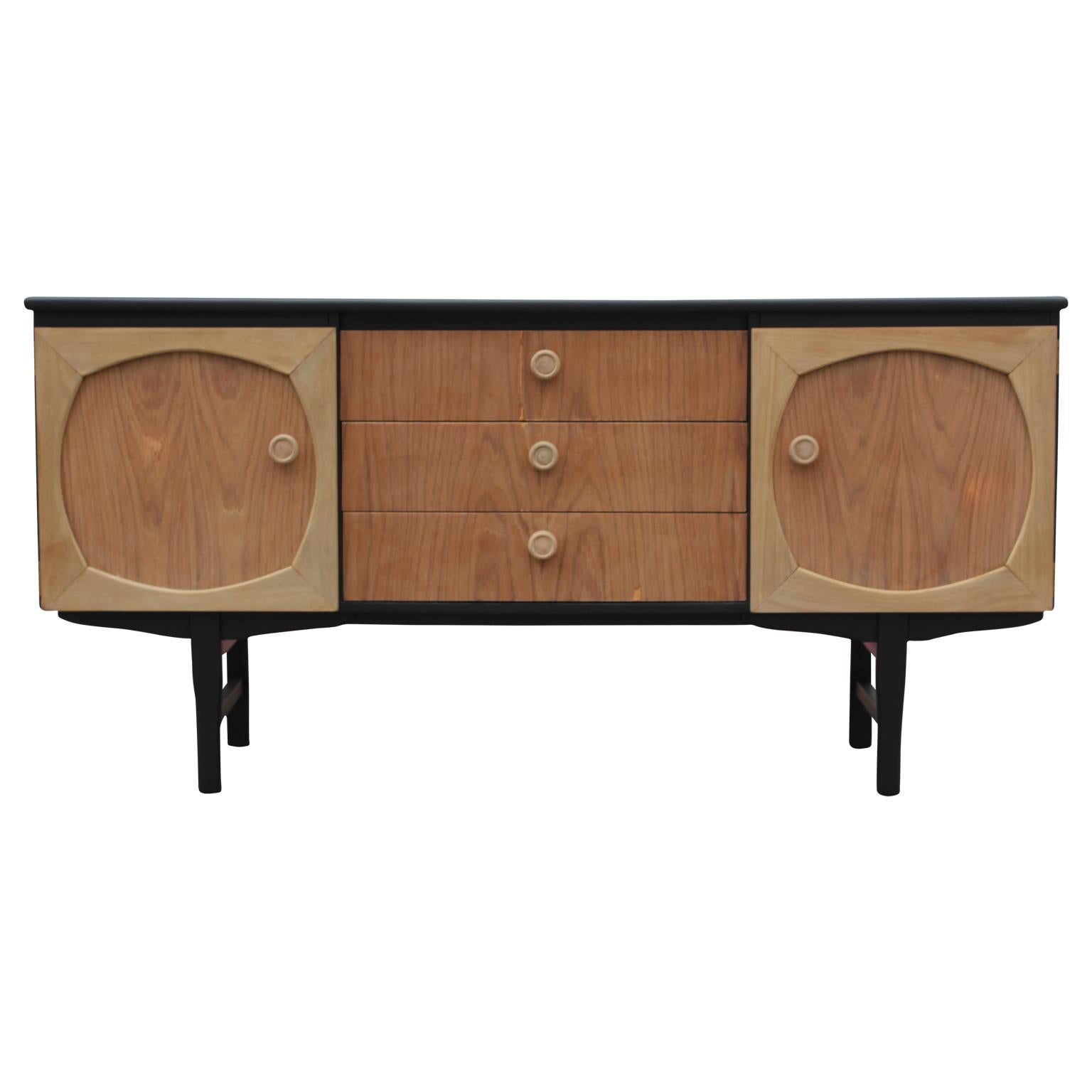 Wonderful modern Danish style custom sideboard / credenza. It has a newly completed black and natural wood finish and wooden handles. This credenza has three center drawers and two cabinet doors with one interior shelf.