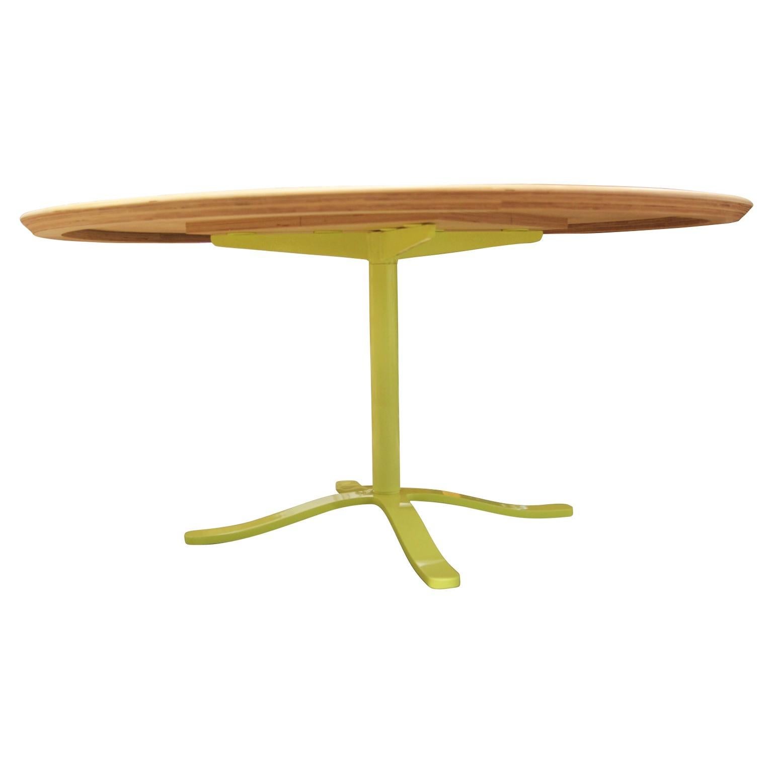 Unique custom round dining table with a neon yellow steel base. The top is made from light solid oak and is in the Mid-Century Modern style. Made in Houston, TX by Reeves Design + Art local craftsman team.