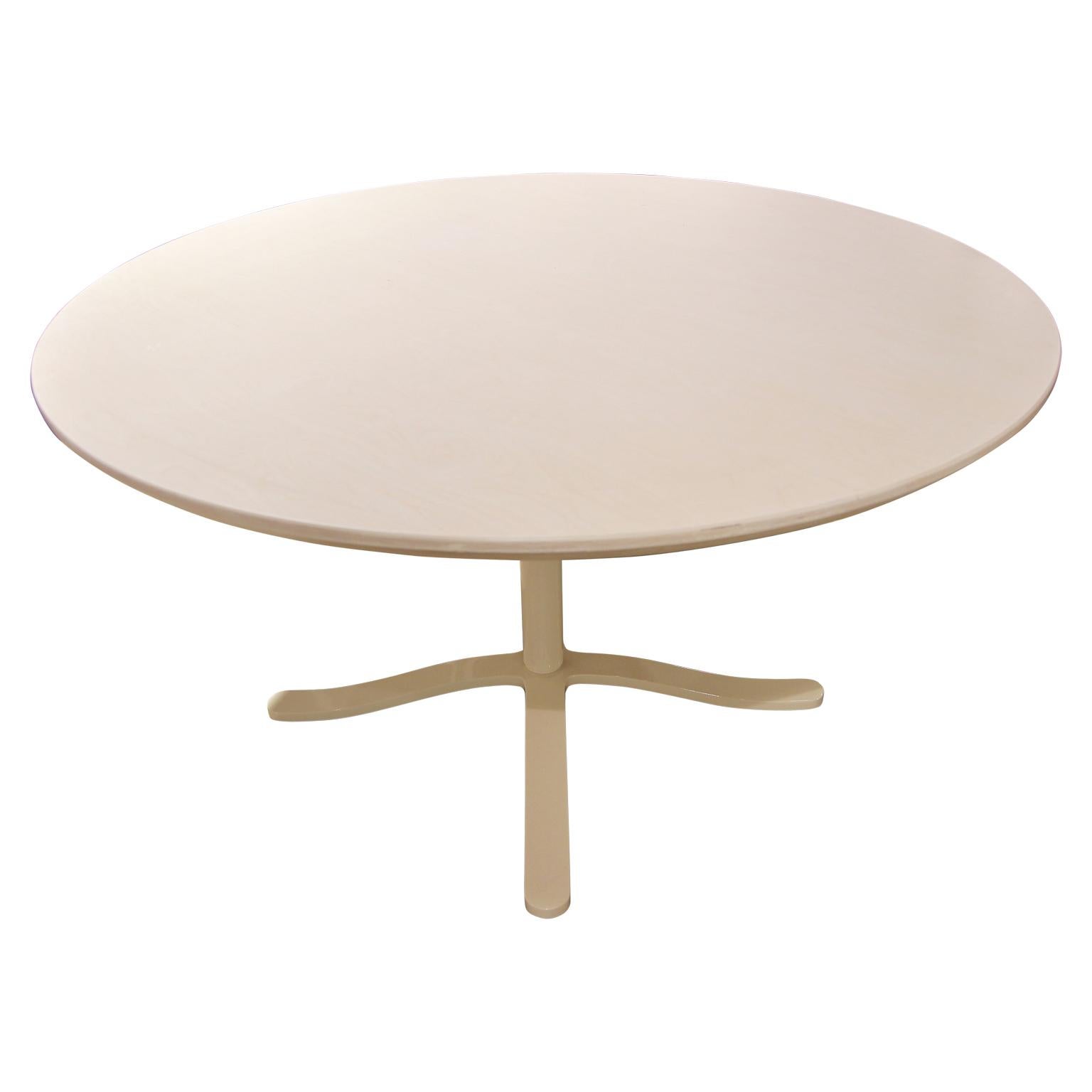 Unique custom round dining table with a white powder coated steel base. The top is made from light oak with a white stain and is in the Mid-Century Modern style. Made in Houston, TX by Reeves Design + Art local craftsman team. Despite the picture