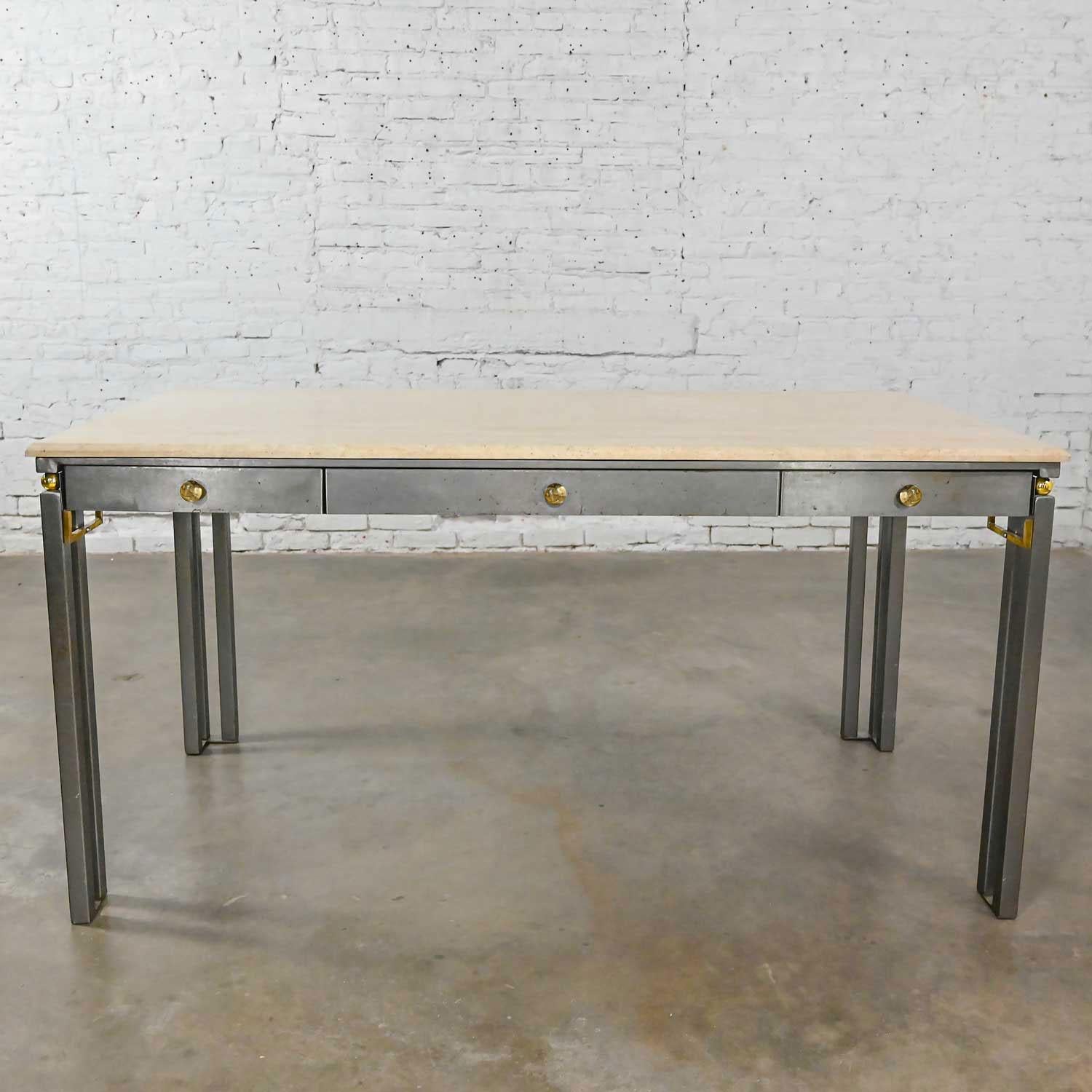 Handsome modern custom-made writing desk by Jensen Design Inc comprised of a square steel tube base with natural steel finish, 3 drawers, brass plated sphere details, solid brass corner detail, and a travertine tabletop with natural filled and honed