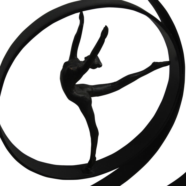 Dancing figure surrounded by concentrical circles placed atop a black base, which acts as a small stage for her performance.

Measures: 4