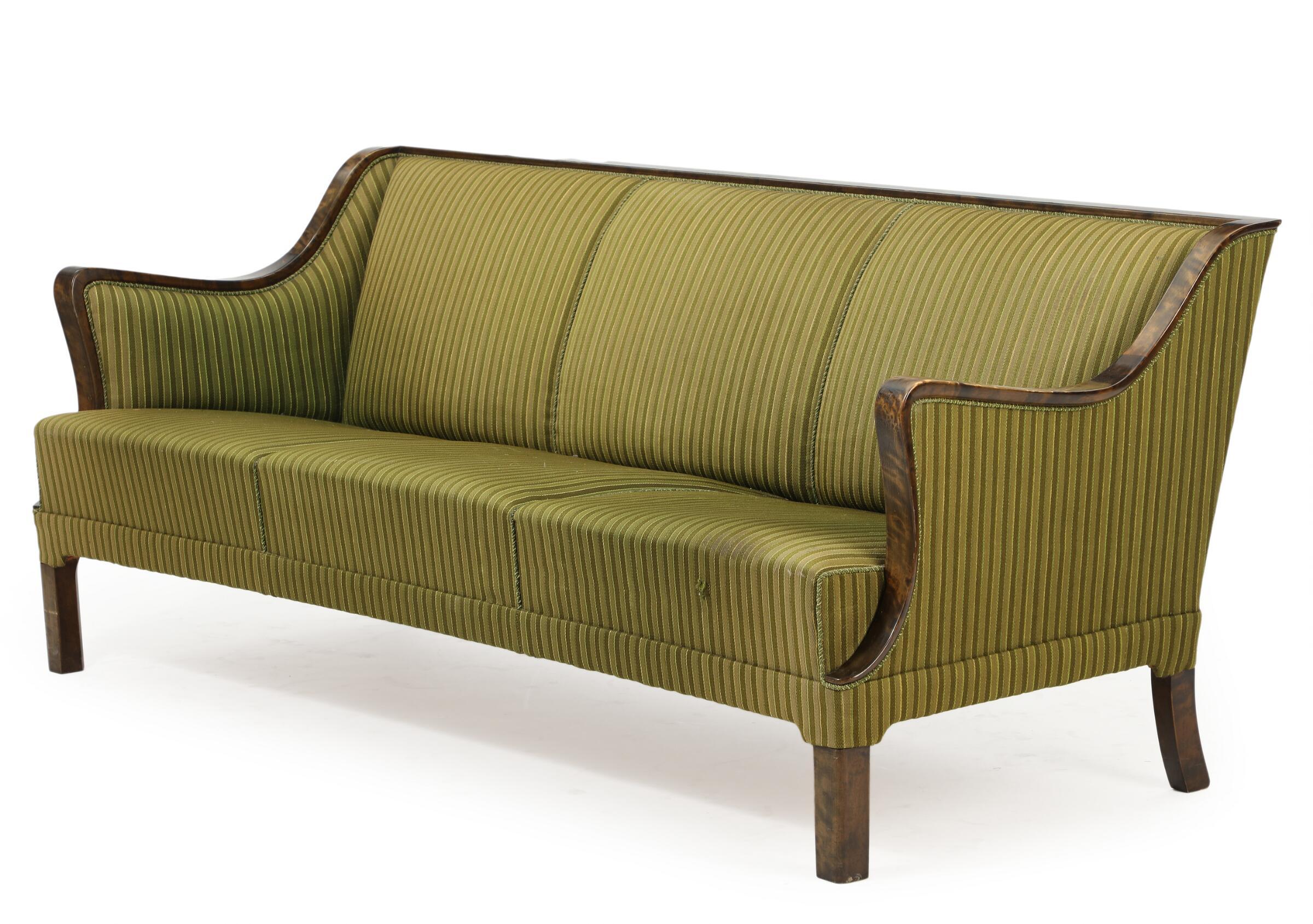 Frits Henningsen is famous for his Classic sofa designs most of which were produced between 1935 and late 1940s. This sofa is supposedly one of his later designs a with sharper and more modern angles. Quite rare this 1950s sofa has a beautiful frame