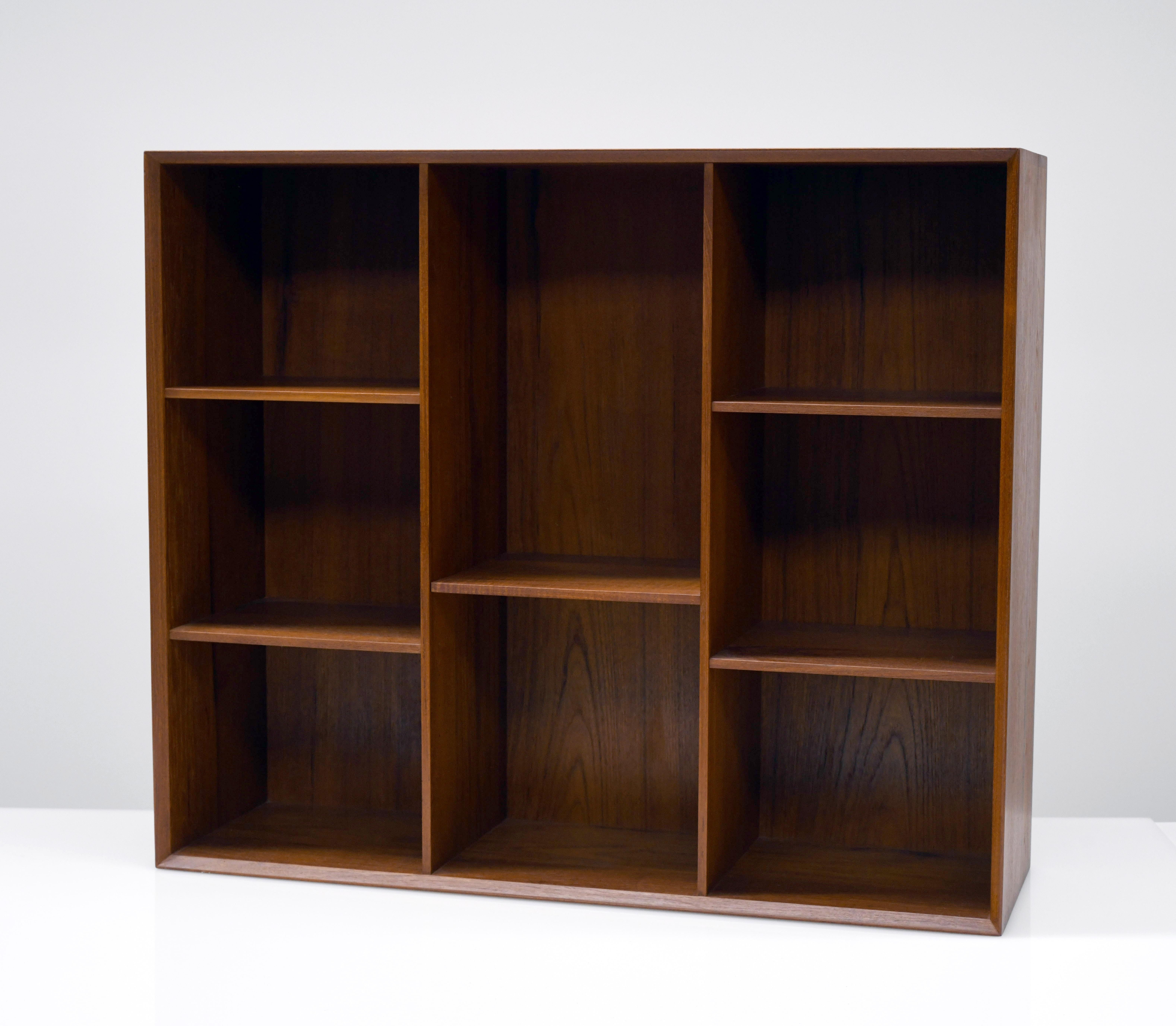 Beautifully constructed bookcase by Peter Hvidt and Orla Mølgaard-Nielsen. Bookcase is clean and in excellent condition. Cabinet is made from solid teak with exposed finger joined details and nice even patina. Bookcase was originally acquired in