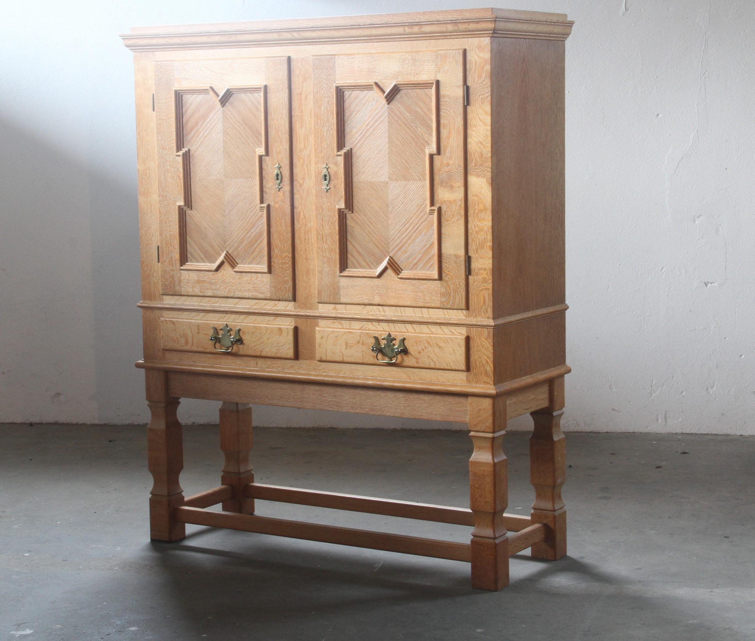 A Danish Mid-century Modern cabinet made from Nordic oak. Manufactured in Denmark during the 1960s and often attributed to the renowned Danish designer Henning/Henry Kjærnulf. Kjærnulf is globally recognized for his unique fusion of Scandinavian