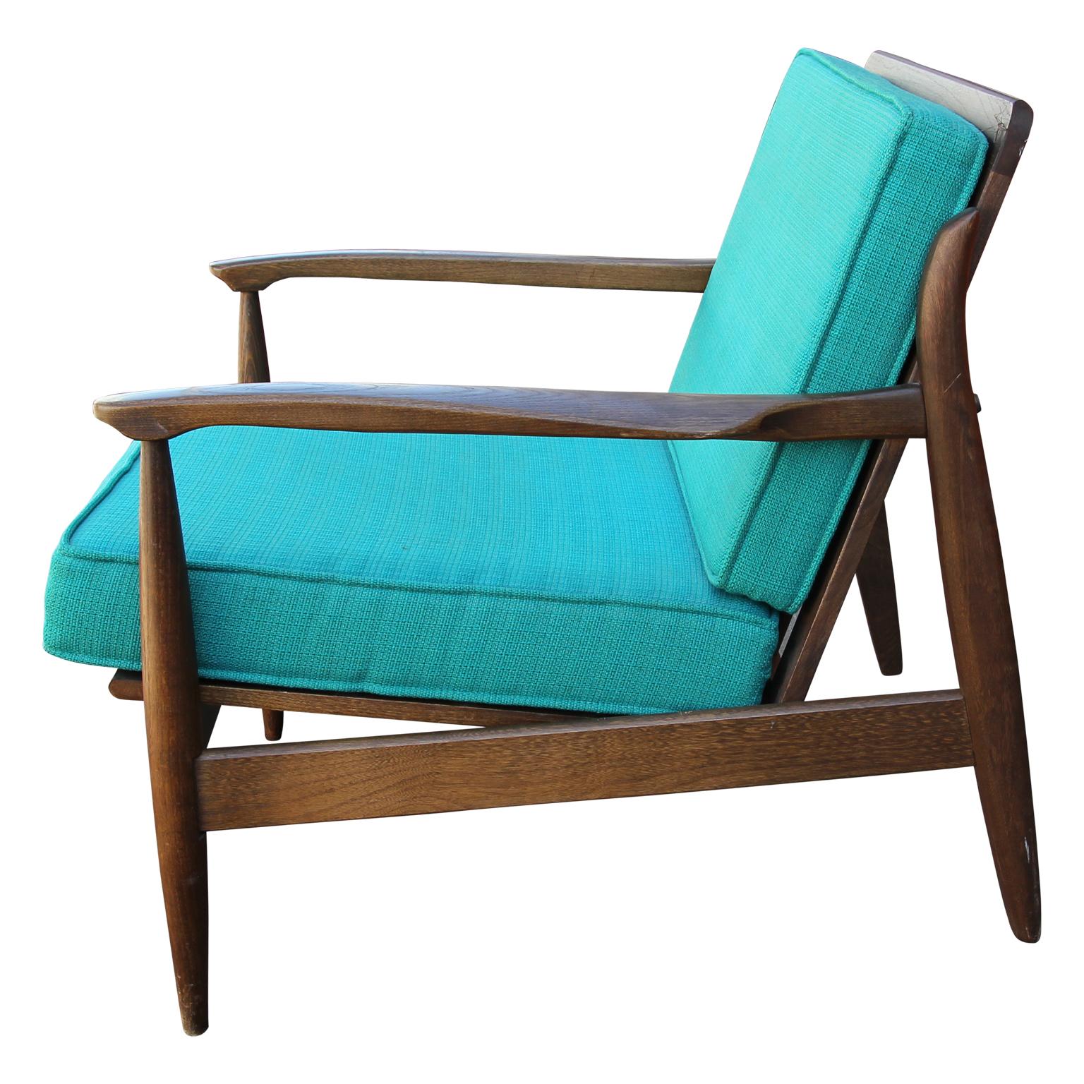 Fantastic teak lounge chair in the Danish style of Svend Age Madsen. The blue upholstered cushions add a pop of color. A wonderful example of minimal modern design. 


  