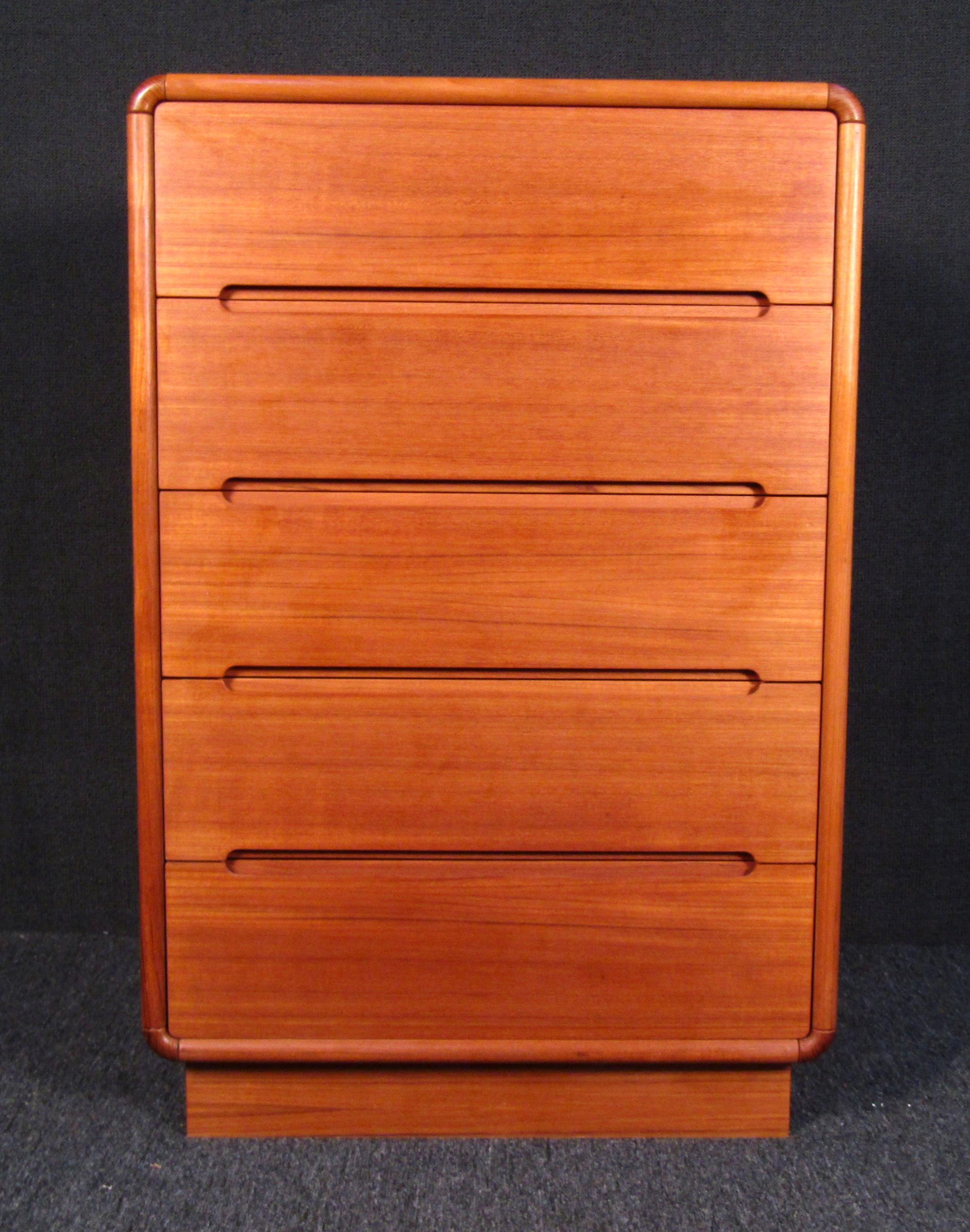 This gorgeous Danish teak highboy dresser features a unique rounded-edge design and finished back. Beautiful recessed drawer pulls accent this quality piece. Cross-grain corner trim highlights that natural wood grain. 

Please confirm item