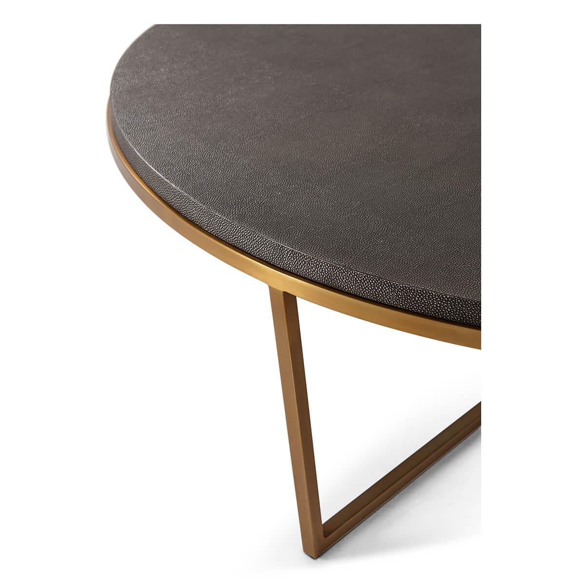 A modern leather top coffee table with a stepped edge. This circular embossed dark leather top rests on a polished brass finish base.

Dimensions: 47.25