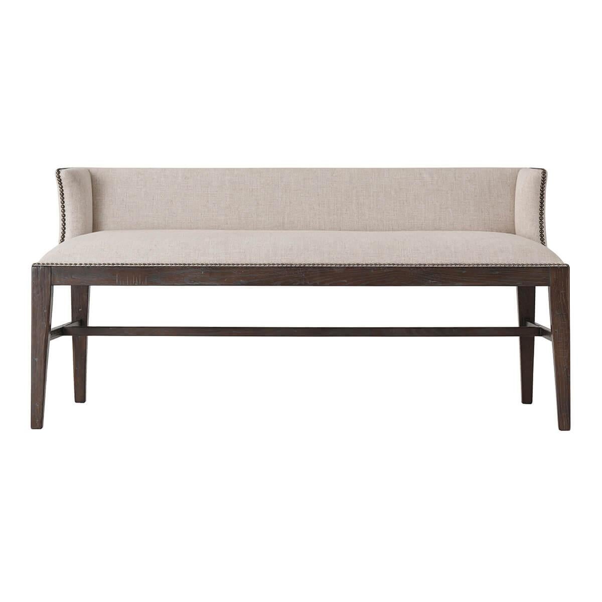 A modern dark oak upholstered bench with an upholstered low winged backrest with nailhead detailing one square tapered legs with an H-form stretcher base.
Dimensions: 54