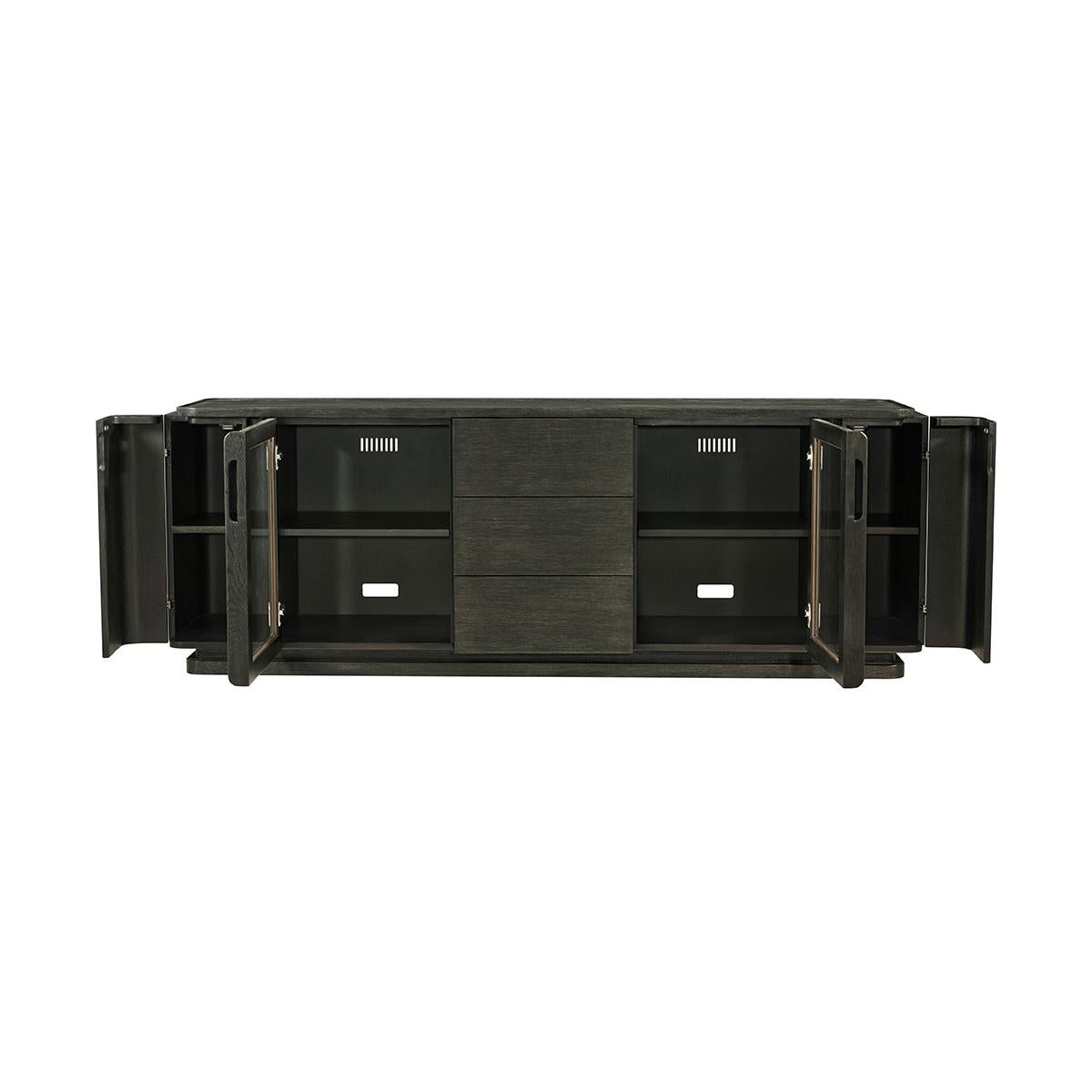 With an amazing amount of storage for all your media. Two glass front cabinets with adjustable shelving, cord cutouts and vents at the back.
Hidden on the ends are curved doors that conceal two small shelves to store away small items, and three,