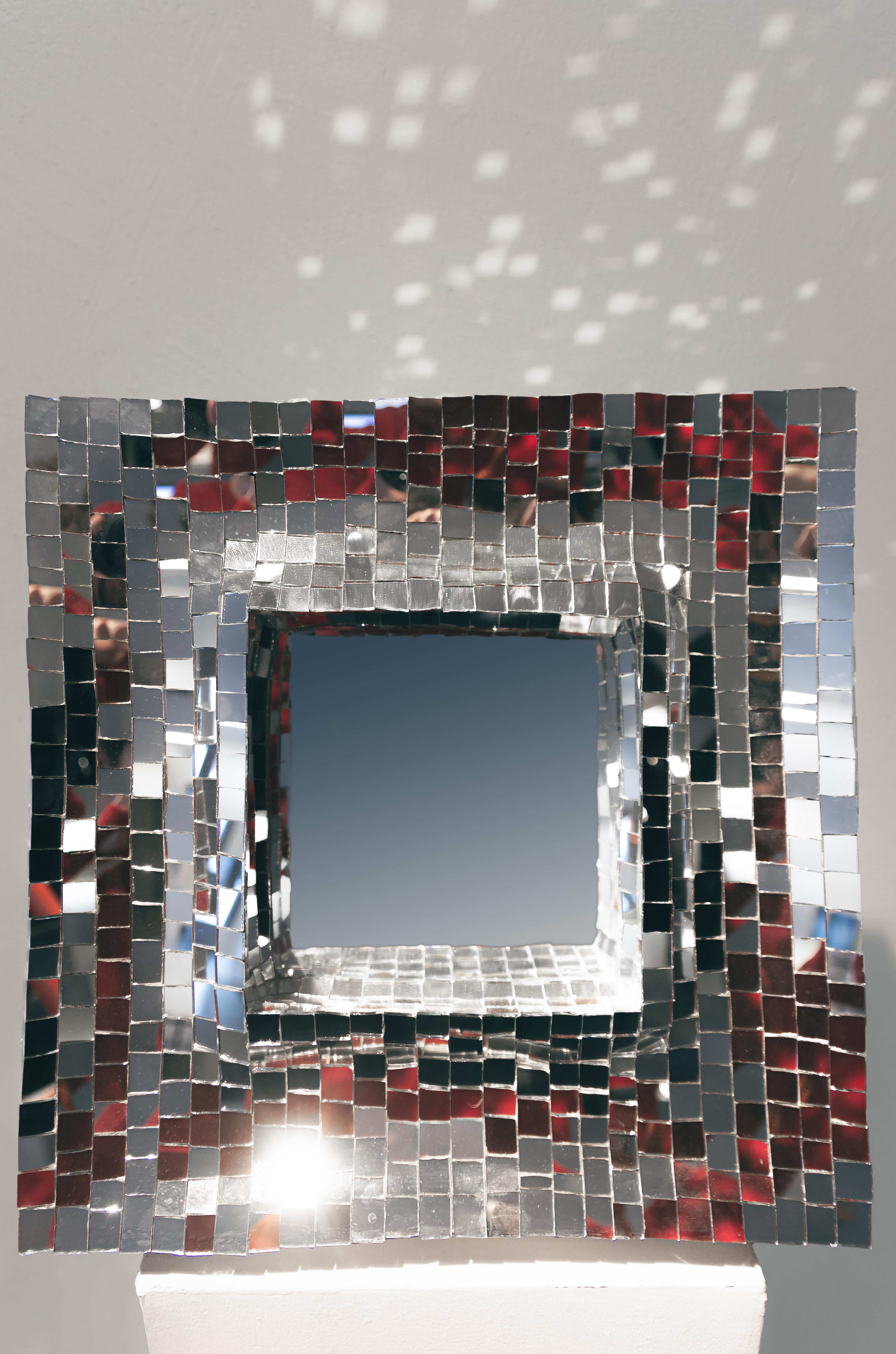 Square table mirror made in silver glass mosaics for Dilmos Milano. Each tile is hand-cut by the designer. 

Available in silver or gold versions.

Size of single segment:
cm 40 x 28 x 40 H.