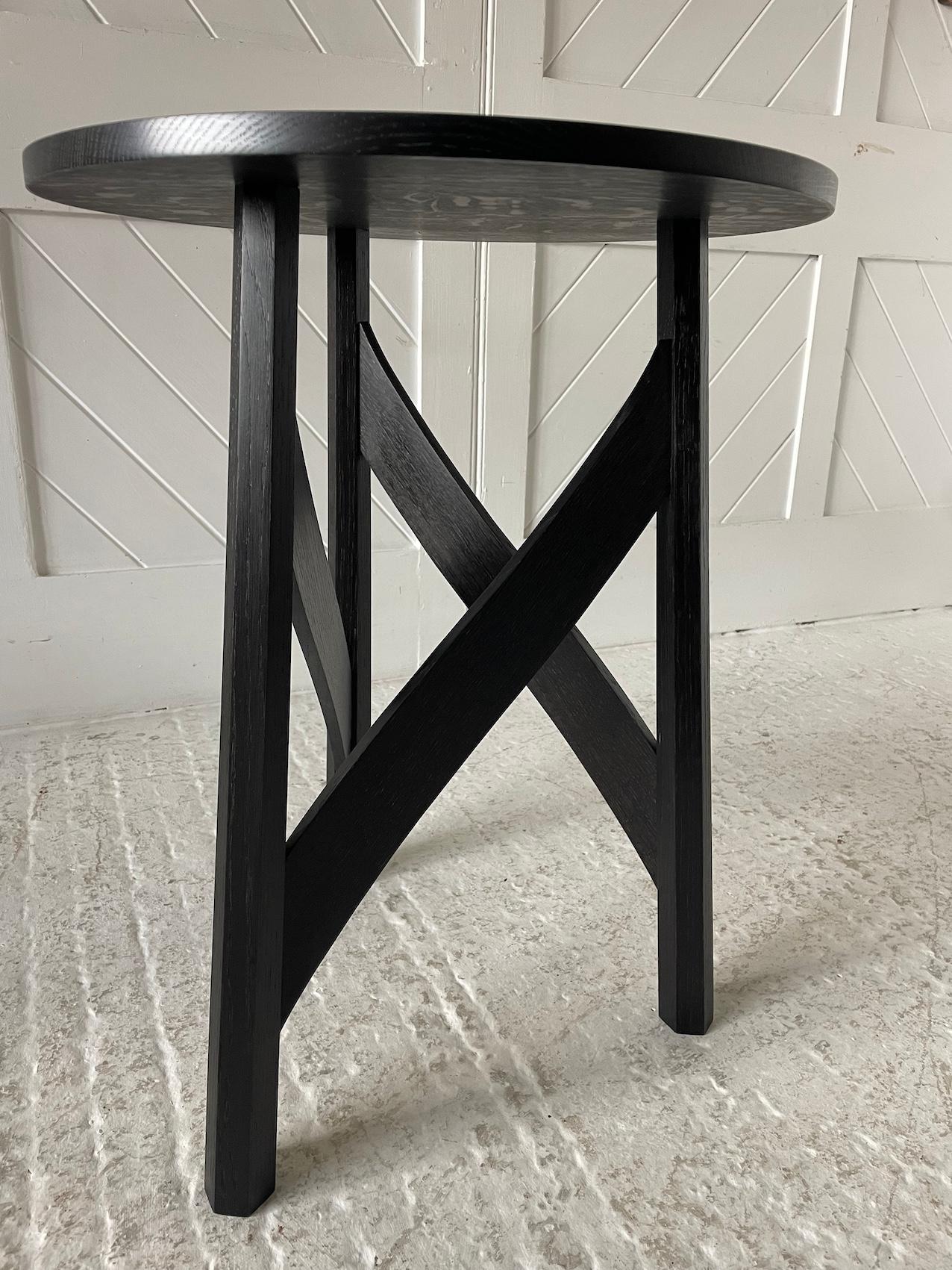 Hand made circular side-table in quarter sawn English Oak with three through jointed splayed flared octagonal legs united by shaped rails, two plank oak quarter-sawn top. This is an ebonised version of our natural oak Craftsman Made Table.

This