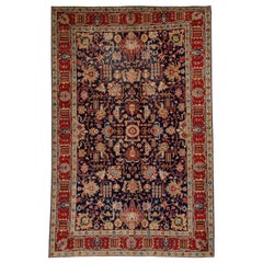 Antigua alfombra persa de Tabriz con motivos florales tradicionales en azul marino y rojo