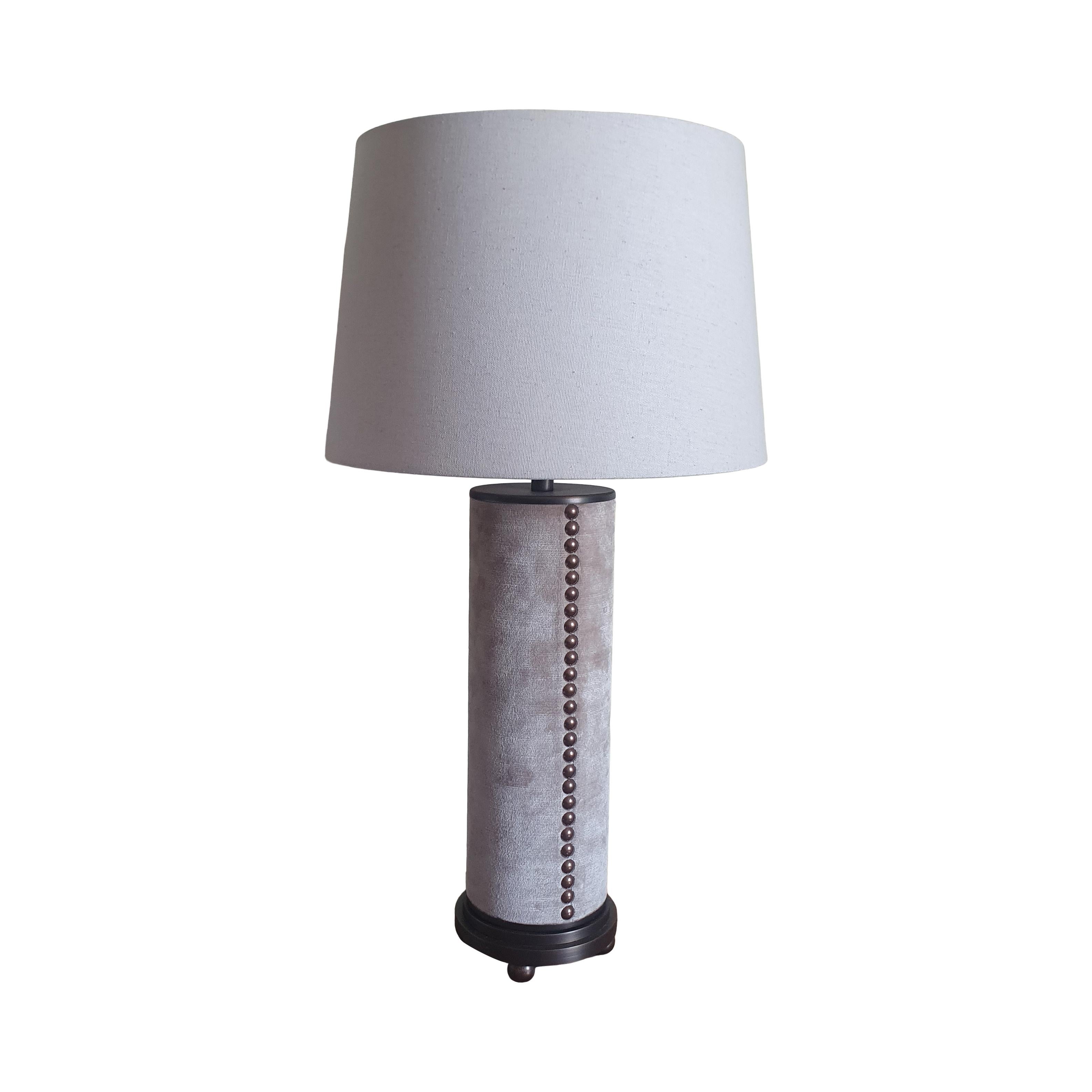 Designed and manufactured by Andrew Kornat Designs, this lamp has a distinctly modern Deco vibe with sleek and elegant proportions from the stepped base raised on elegant feet and topped with the upholstered solid wood column 

Made of 9 pieces of