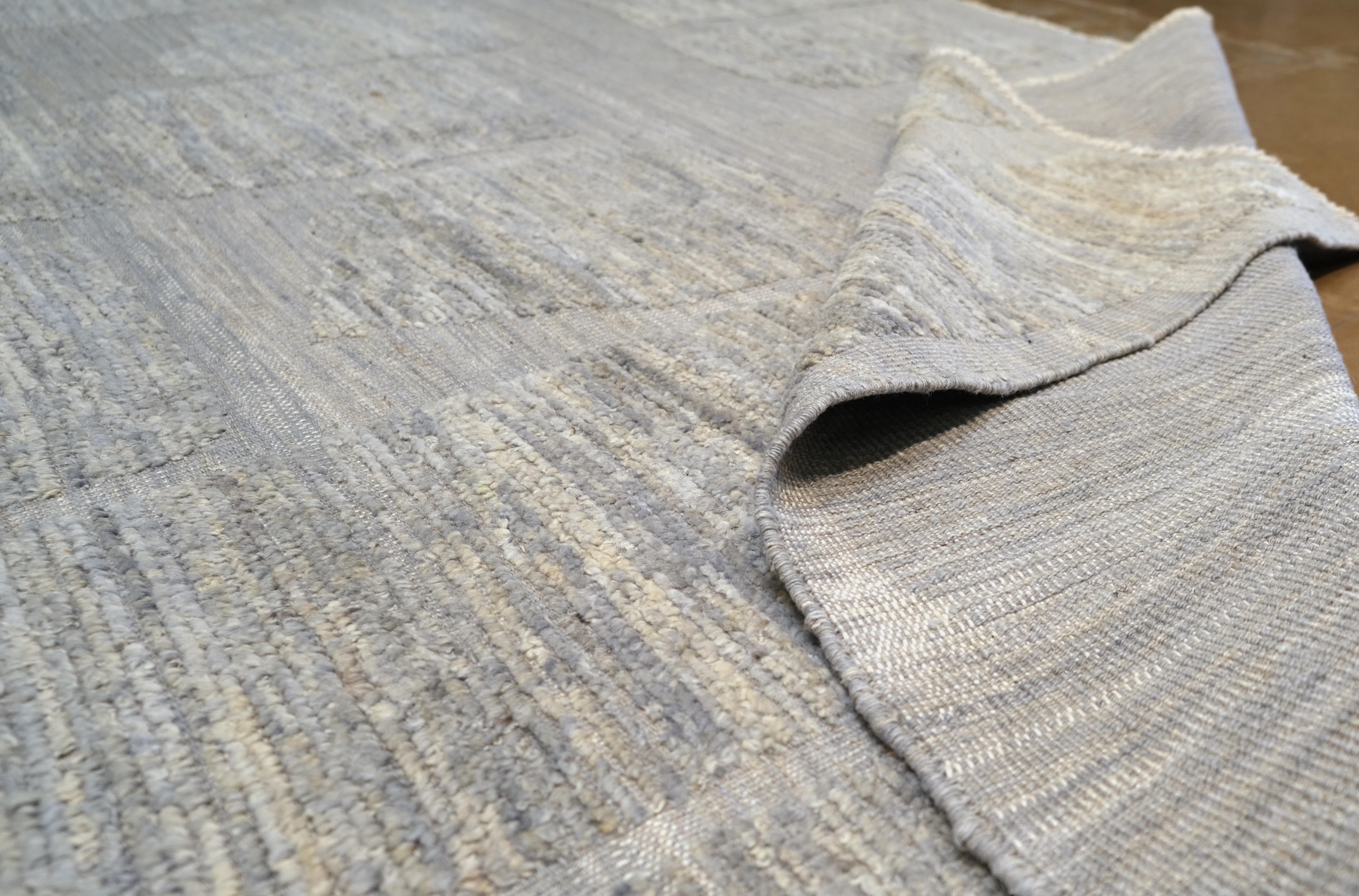 Featuring a delicate geometric grid pattern in soft neutral tones of gray, this rug embodies minimalist sophistication. The understated design is perfect for creating a serene and harmonious ambience, making it a versatile addition to both modern