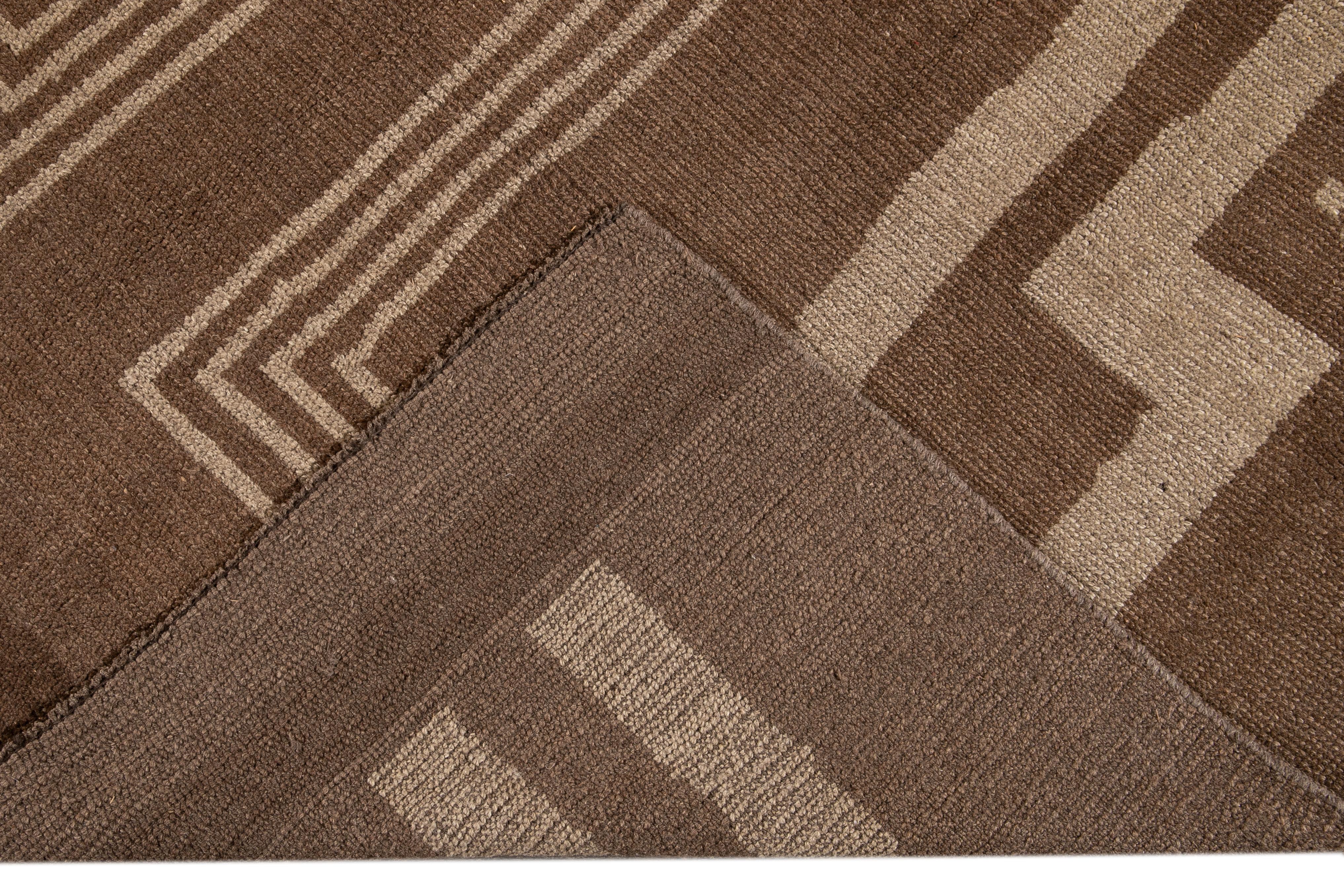 Beautiful Modern Deco-style hand-knotted wool rug with a brown field. This Contemporary rug has accents of beige in a gorgeous all-over geometric design.

This rug measures: 7'1