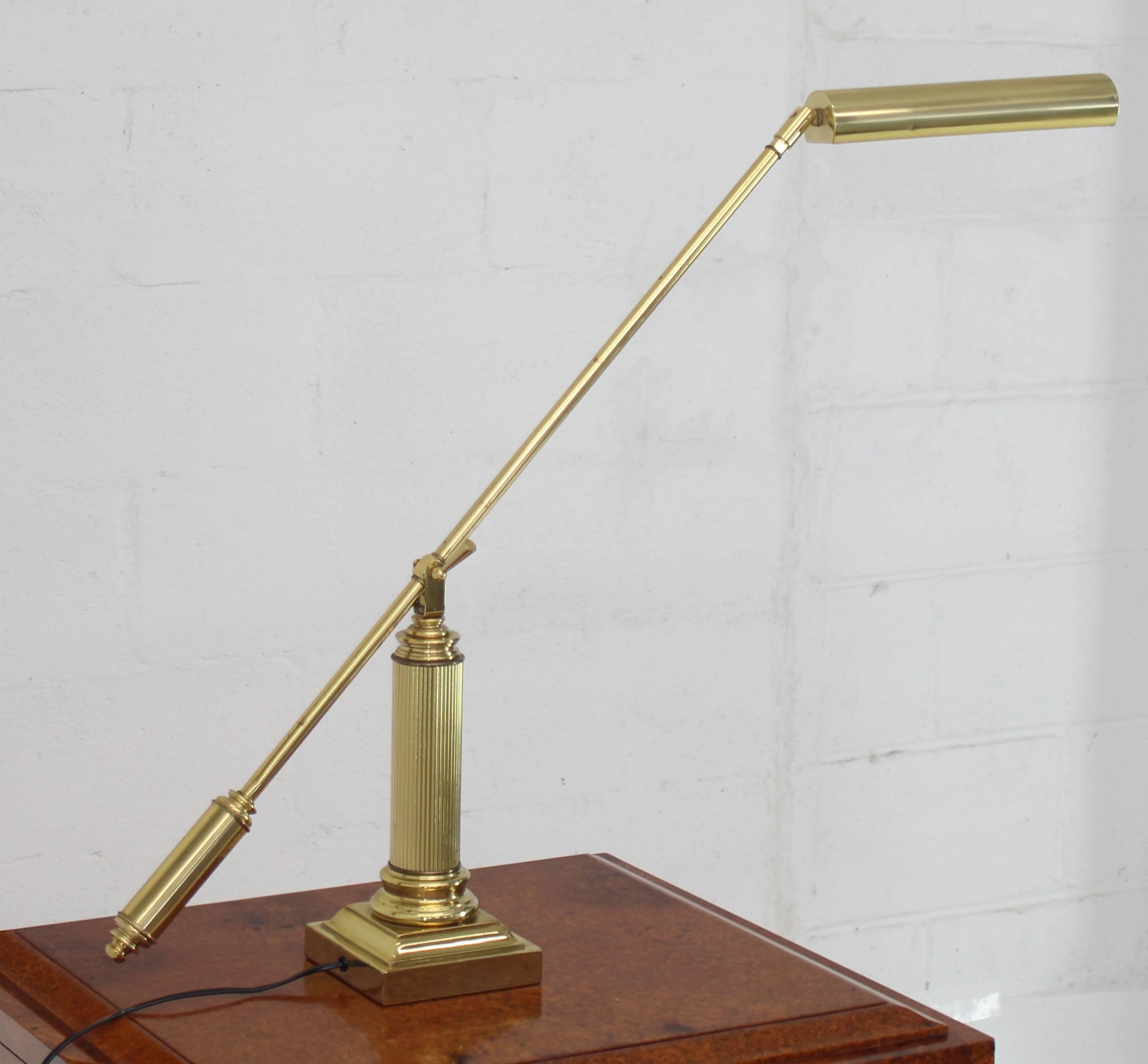 Fully adjustable long arm cantilever reading desk lamp. The length of the arm with the brass shade is 42