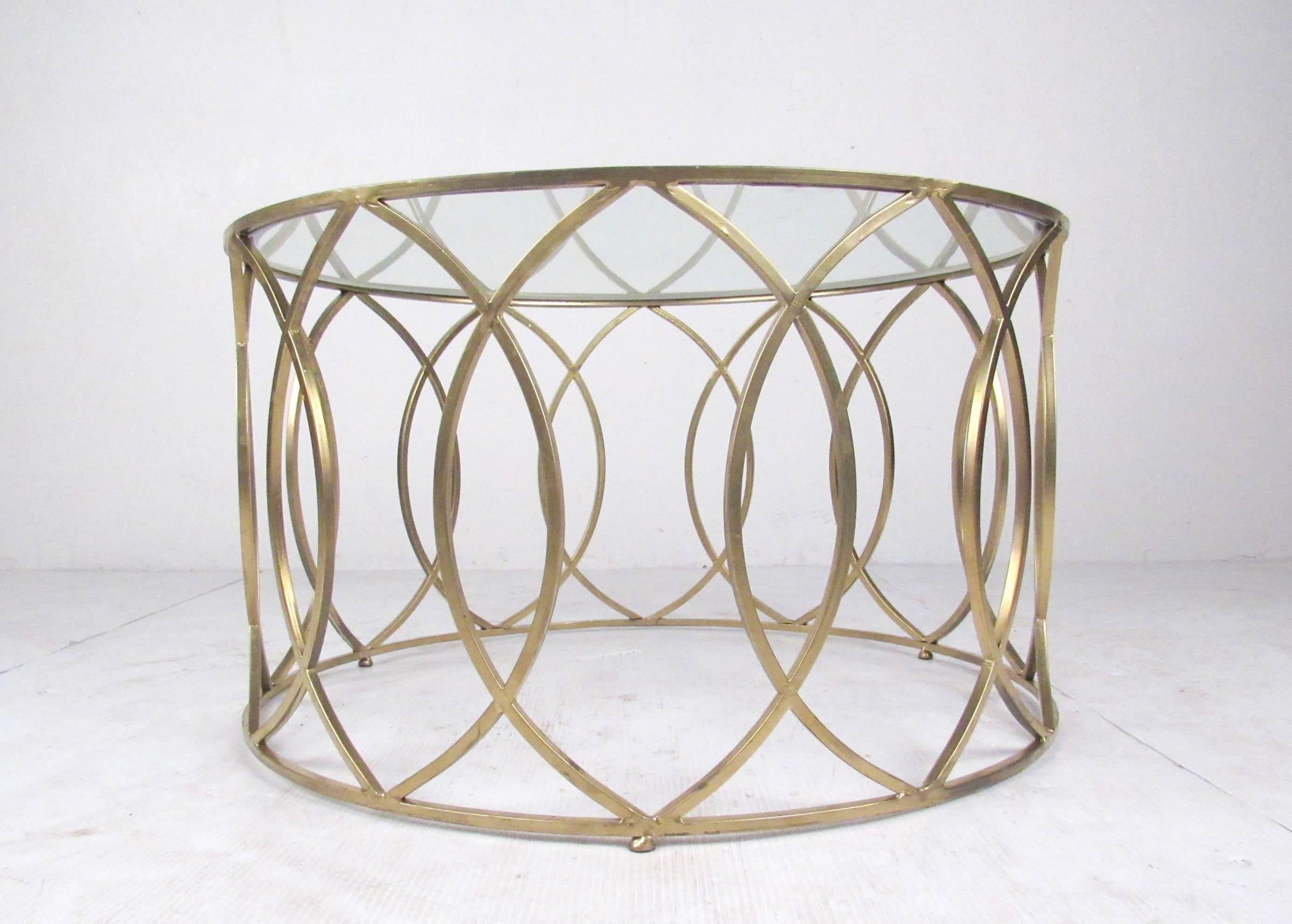 This unique decorator style coffee table features Hollywood Regency appeal with a gold colored finish and unique geometric design. Beveled glass top and multi-functional size make this modern coffee or end table an elegant addition to home or
