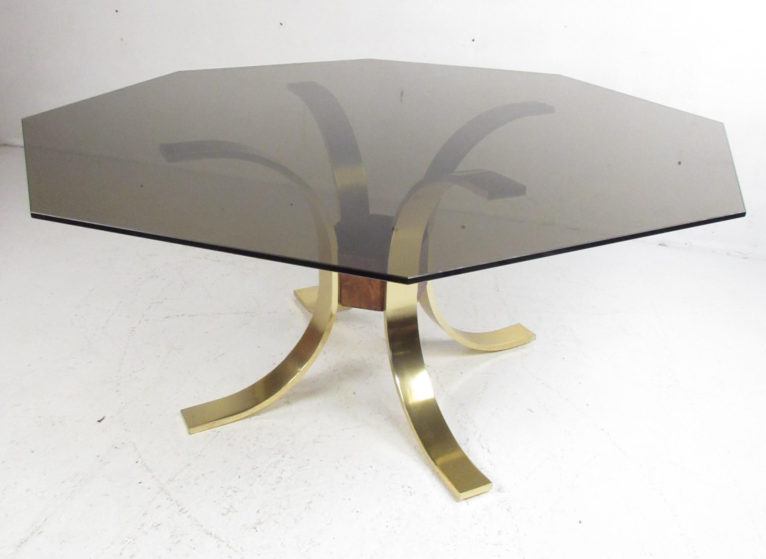 Dramatic hexagonal tinted-glass centre hall table with brass plated arched metal base. Please confirm item location (NY or NJ) with dealer.