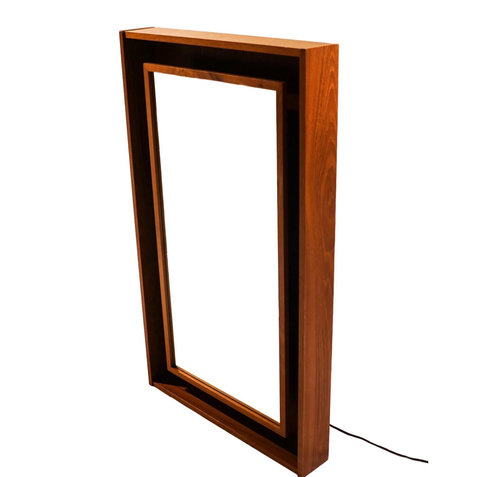 Beautiful large and impressive backlit teak framed Danish rectangular mirror. Made in Denmark by Pedersen & Hansen, a high-end Danish Company. Features a shadowbox teak frame with a floating mirror that lights up from behind the inner frame in a
