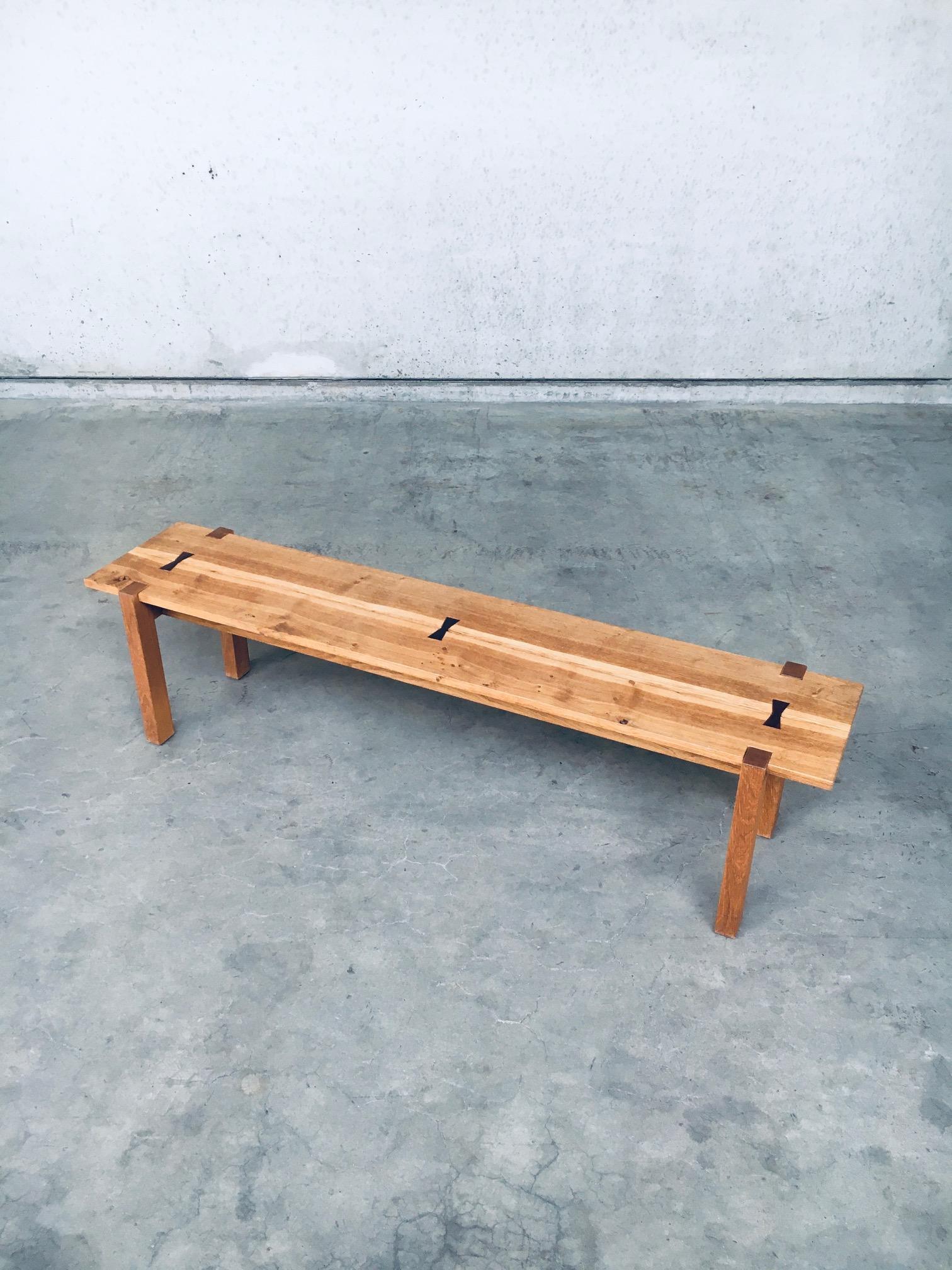 Modern design butterfly jointed planks wooden side bench. Made in Belgium, early 2000's. Wood constructed bench with 2 planks as seat which are jointed with dark wooden butterfly wedges on 4 legs which are set in the top planks. Nice designed bench.