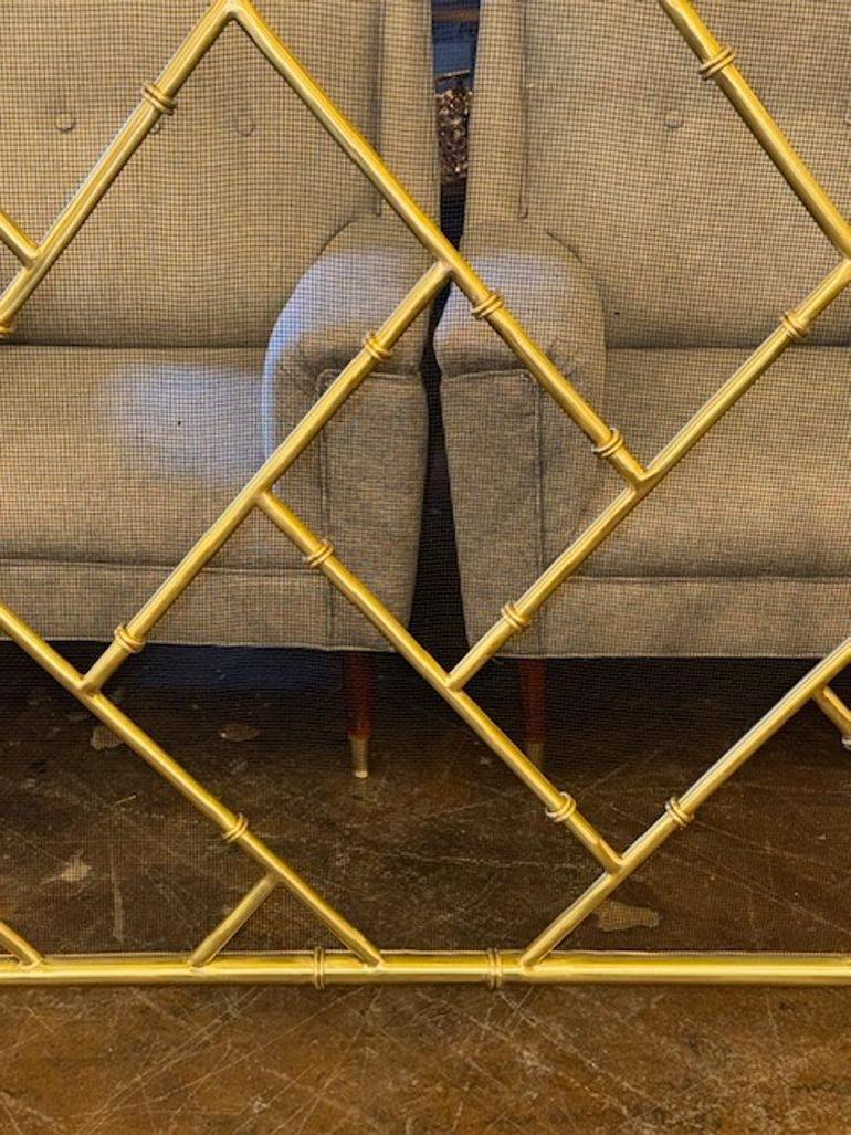 This fire screen features a modern design with a custom brass bamboo form, adding a touch of elegance to any fireplace. The screen is specifically designed to enhance the aesthetic of a contemporary space, making it a stylish addition to your home