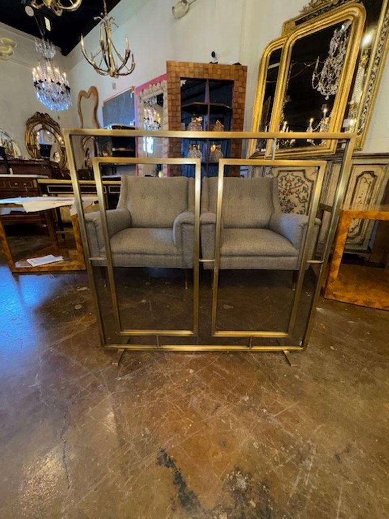 This is a modern custom-made fire screen that features a gorgeous brass finish, giving it a sleek and stylish look. The screen is designed to enhance the appearance of a fireplace while providing protection from sparks and embers. Its modern design