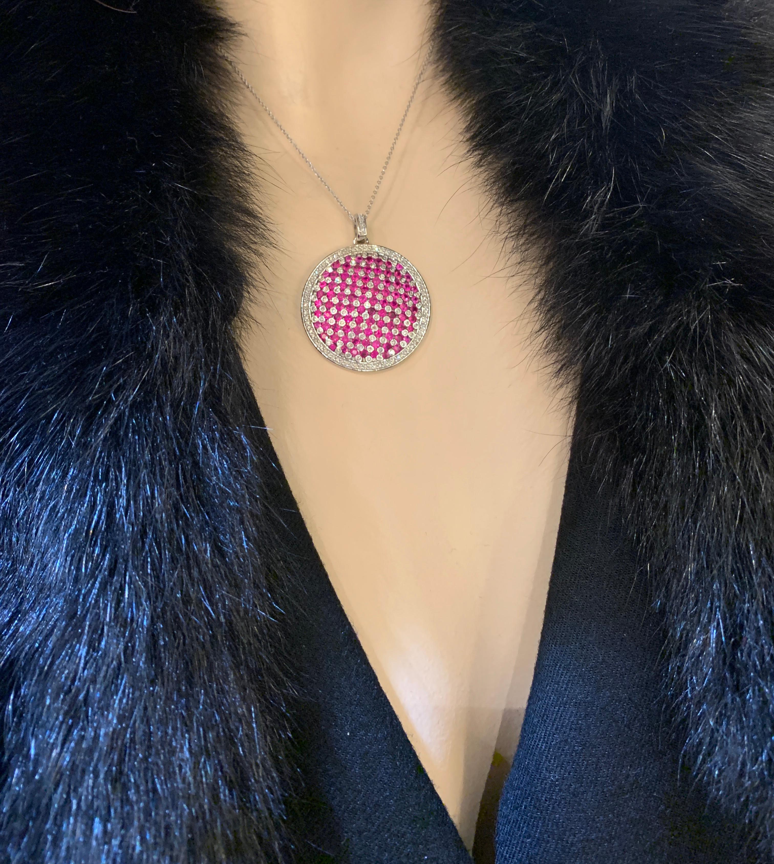 Fabulous circular modern design ladies 14 karat white gold designer “Effy” ruby and diamond pendant features a striking checkerboard design accented with a diamond border surround. The rubies are the most beautiful vivid red color and are very