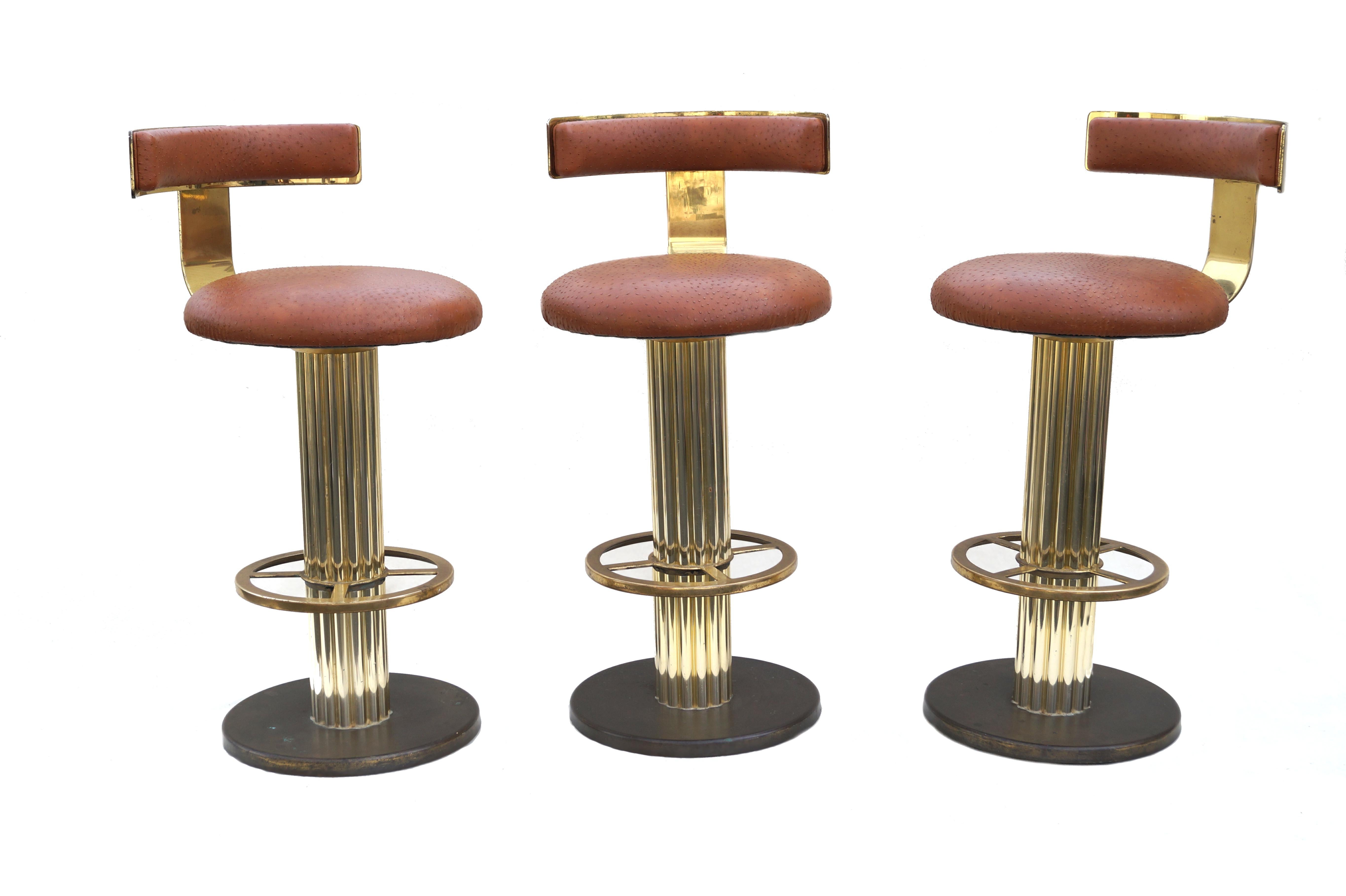 Design For Leisure  brass bar stools set of 3. Has Faux Ostrich upholstery.