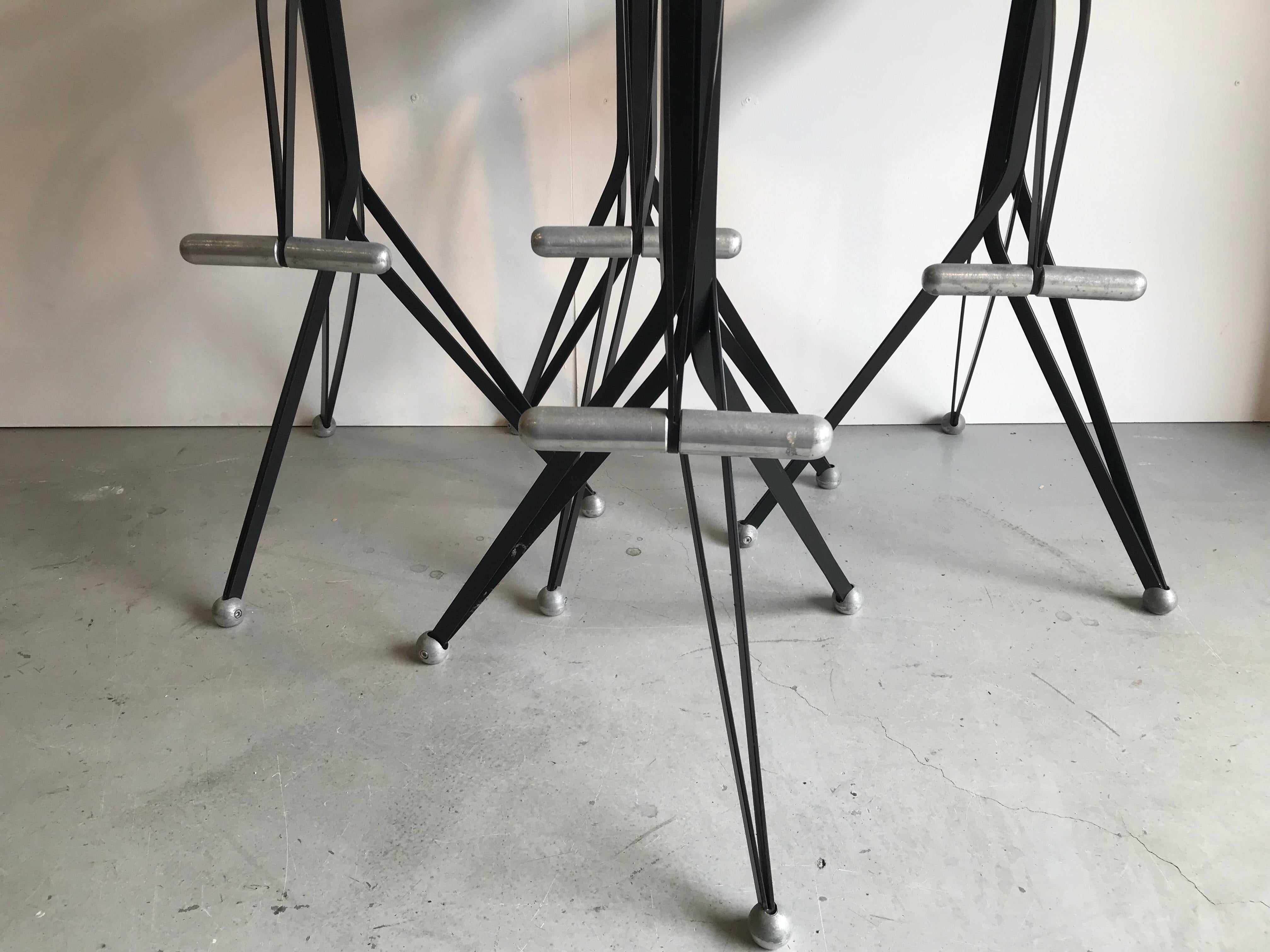 Four very rare barstools designed by Ron Arad for the Italian company ZEUS. Late 1980s design.
The stools are adjustable in height and turnable. They are surprisingly comfortable and you also have a footrest.
Black metal with aluminium details and