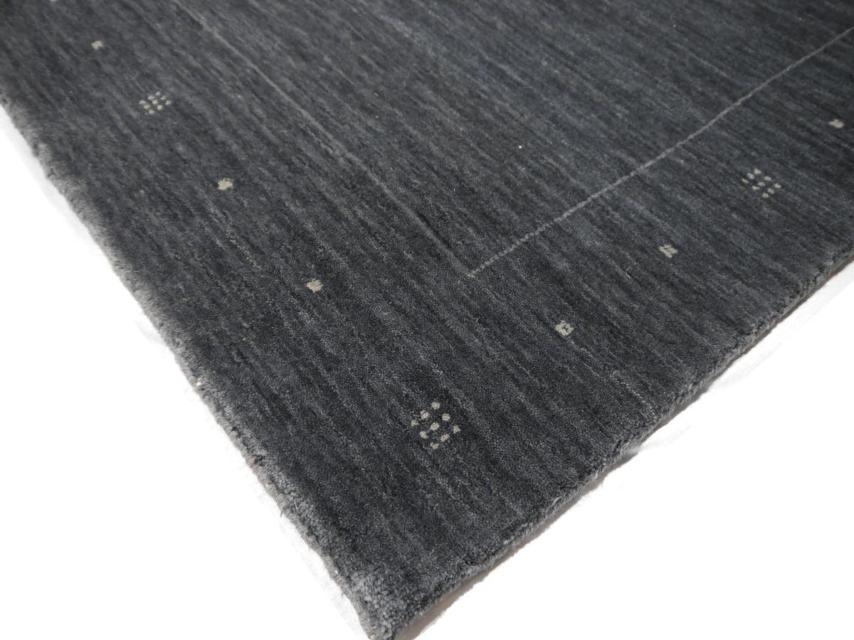 A contemporary modern design rug in charcoal.

This beautiful rug was handmade to fit 21st century interior needs. The background is in an elegant charcoal color minimalistic design. A small stripe in gray color contrasts to the field.

The