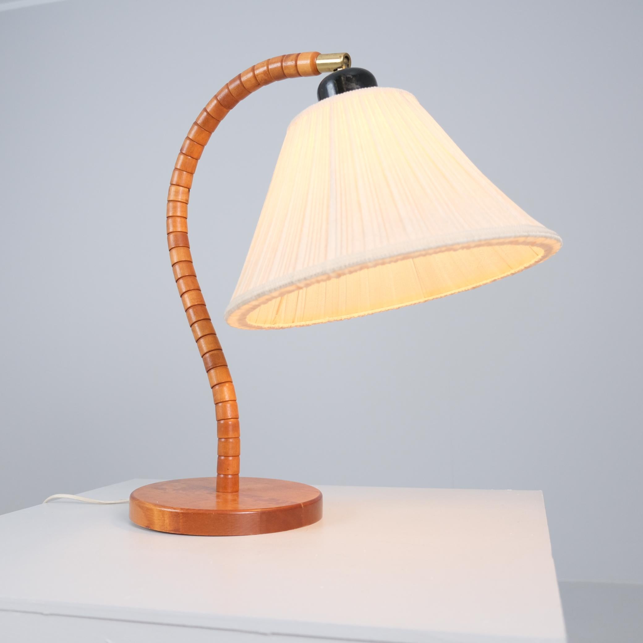 Lámpara escultórica de sobremesa escandinava moderna modelo 1911 de Markslöjd, Suecia, fabricada en la segunda mitad del siglo XX. Esta lámpara de gran tamaño presenta un brazo bellamente curvado hecho de pequeños segmentos de madera torneada