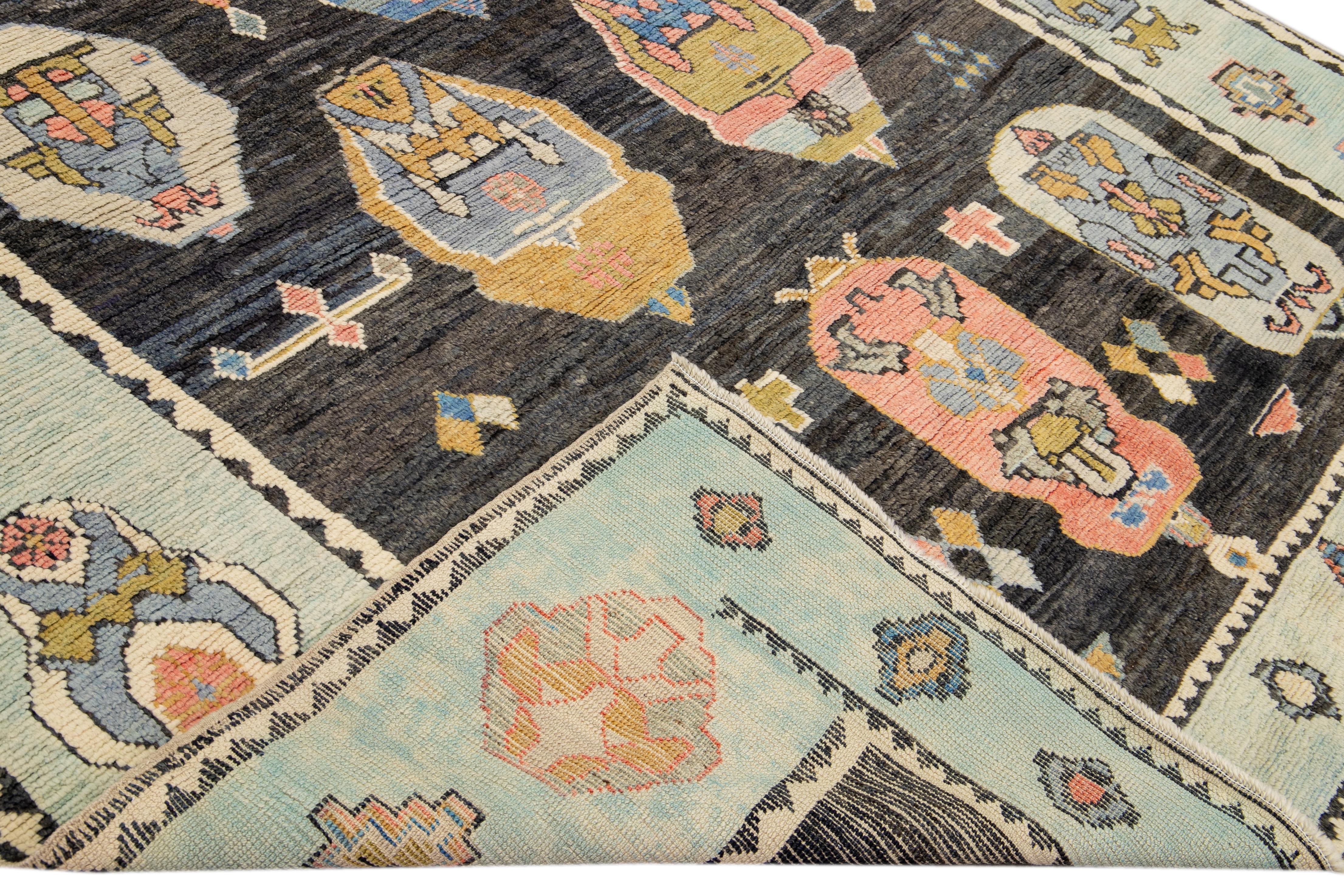 Beautiful modern Oushak hand-knotted wool rug with a gray field. This Oushak rug has a light blue frame and multicolor accents layout a gorgeous geometric floral pattern design. 

This rug measures: 8'3