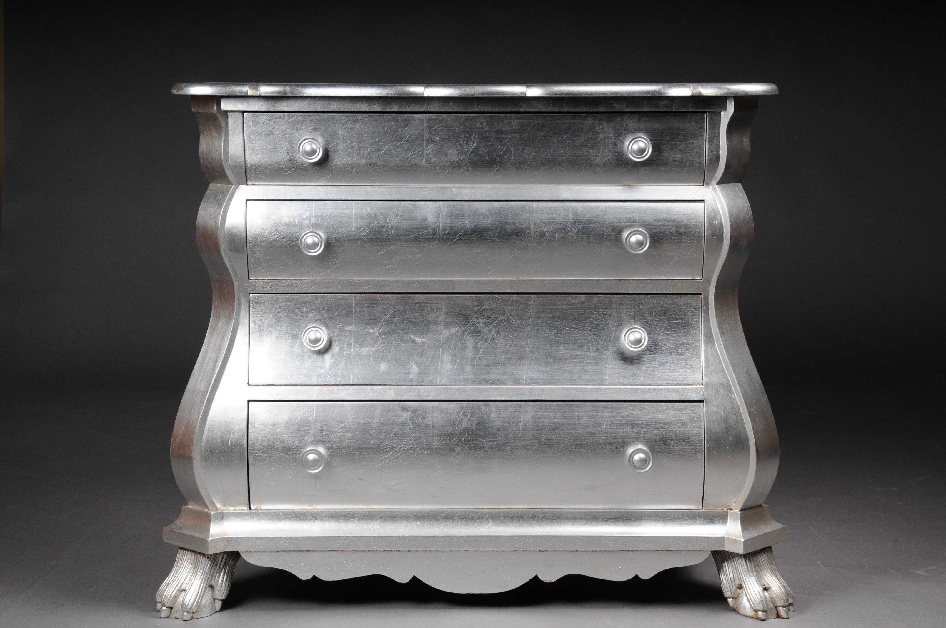 Modern designer baroque chest of drawers, silver leaf.

Solid beech wood and set in silver. Extremely rich, baroque, three-dimensionally carved paw feet, multiple arched frame, above it, cambered, four-drawer body framed by extended corner