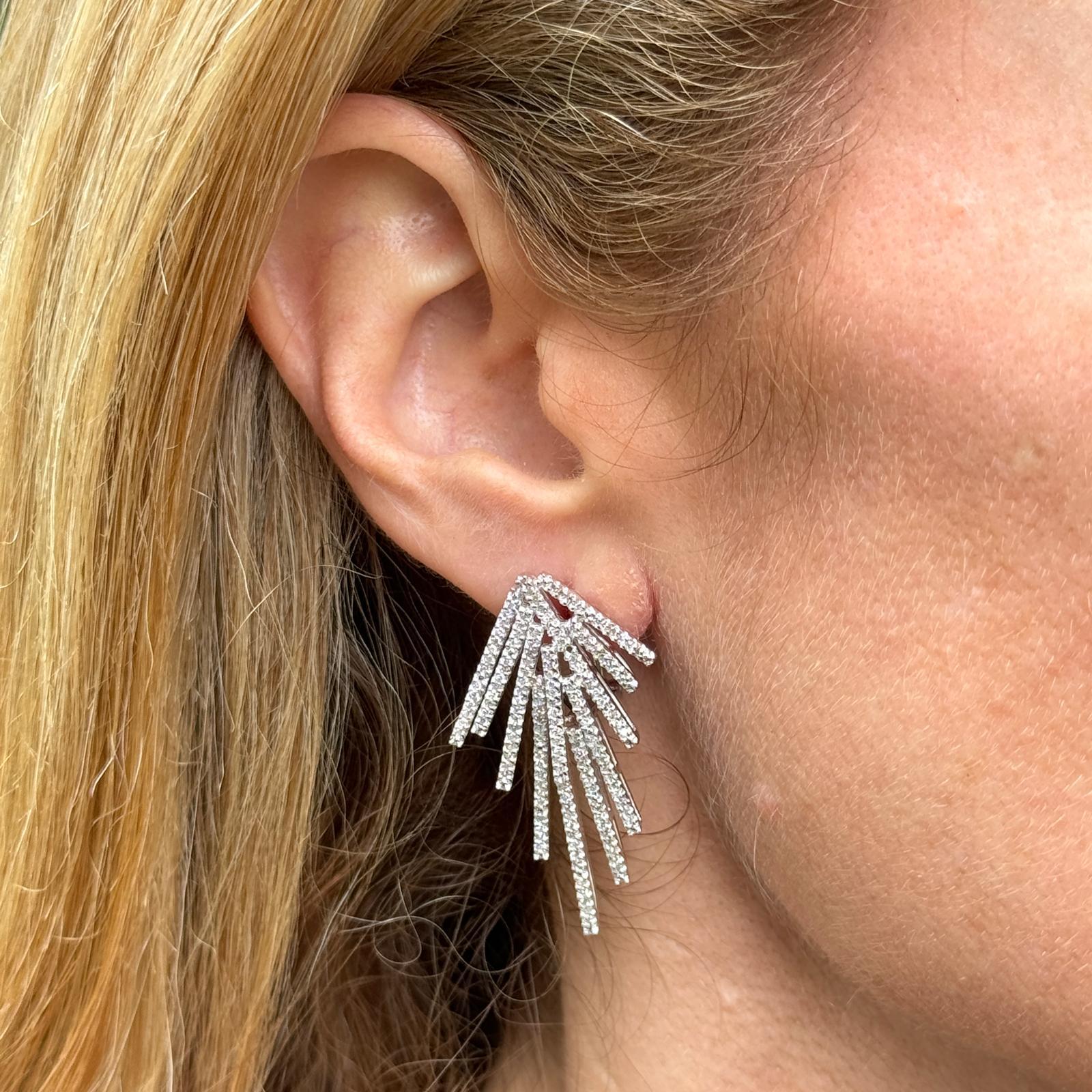 Modern diamond drop firework earrings crafted in 14 karat white gold. The earrings feature 298 single cut round diamonds weighing approximately 1.50 carat total weight. The diamonds are graded H-I color and SI clarity. The earrings measure 1.60