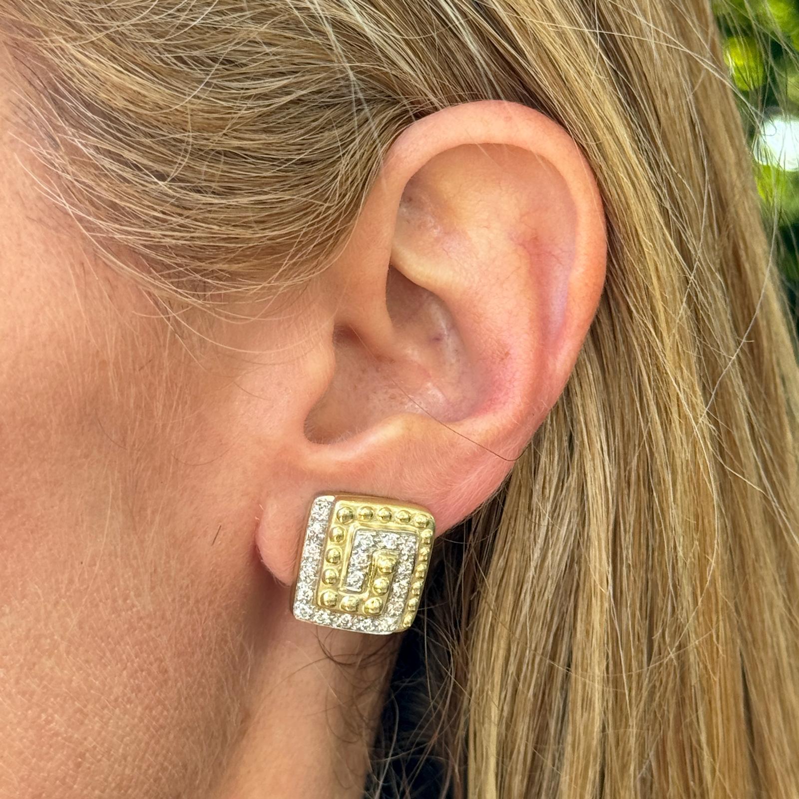Diamond swirl design earrings crafted in 14 karat yellow gold. The earrings feature 32 round brilliant cut diamonds weighing approximately .75 carat total weight and graded H-I color and VS2-SI1 clarity. The square shape earclip earrings measure 16