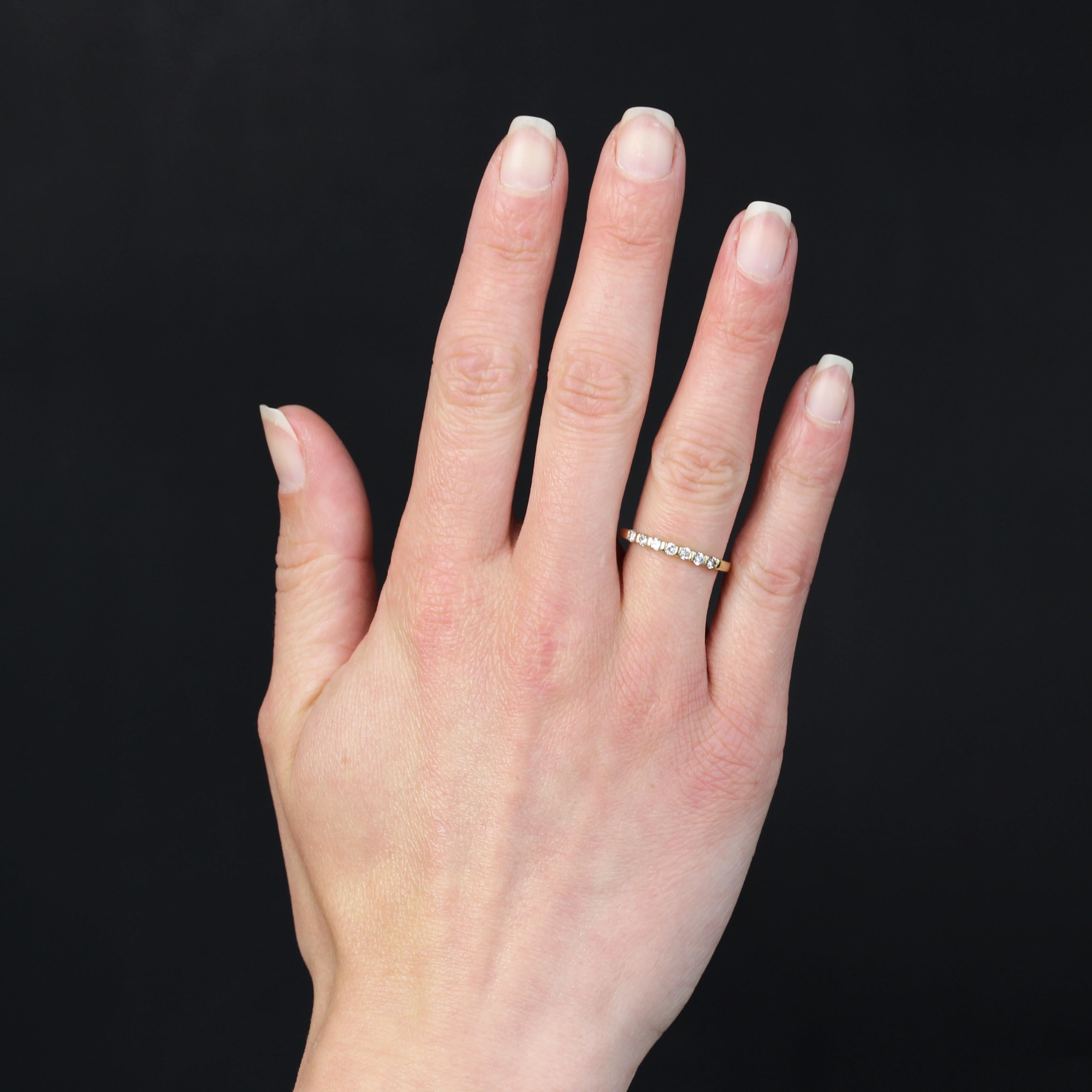 Wedding ring in 18 karat yellow gold.
A half diamond wedding band, its top is adorned with 7 modern brilliant-cut diamonds separated by gold bars.
Total weight of diamonds : 0.21 carat approximately.
Height : 2,1 mm approximately, width : 16,5 mm