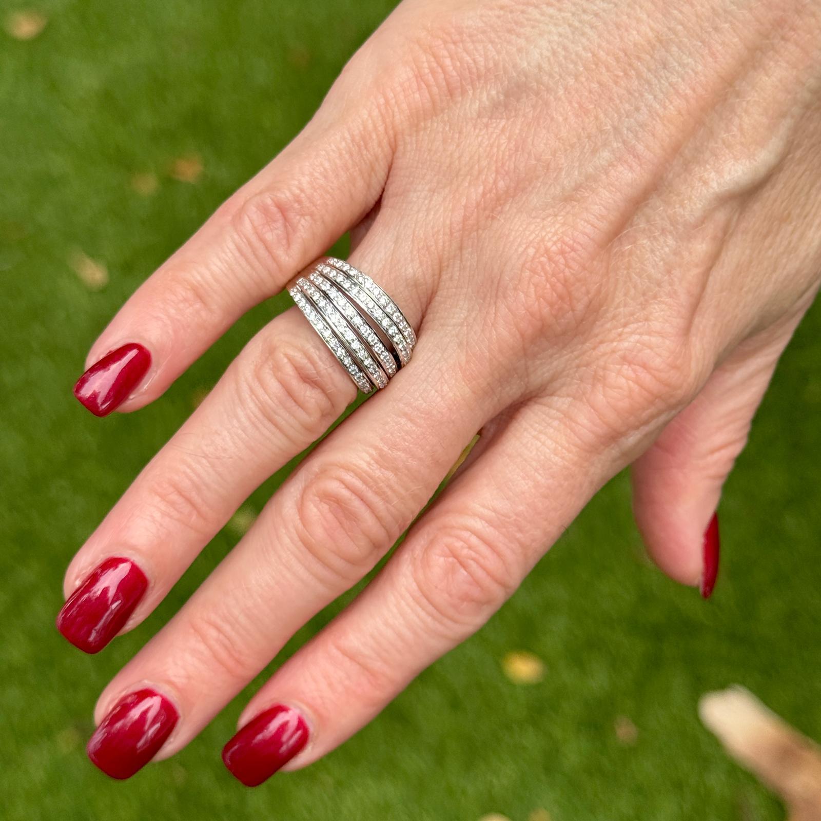 This stunning 18 karat white gold multi-row diamond band ring features 97 round brilliant-cut diamonds, totaling 1.00 carat. With an H-I color and SI clarity, the diamonds are meticulously set to create a dazzling, layered effect. Measuring 12mm in