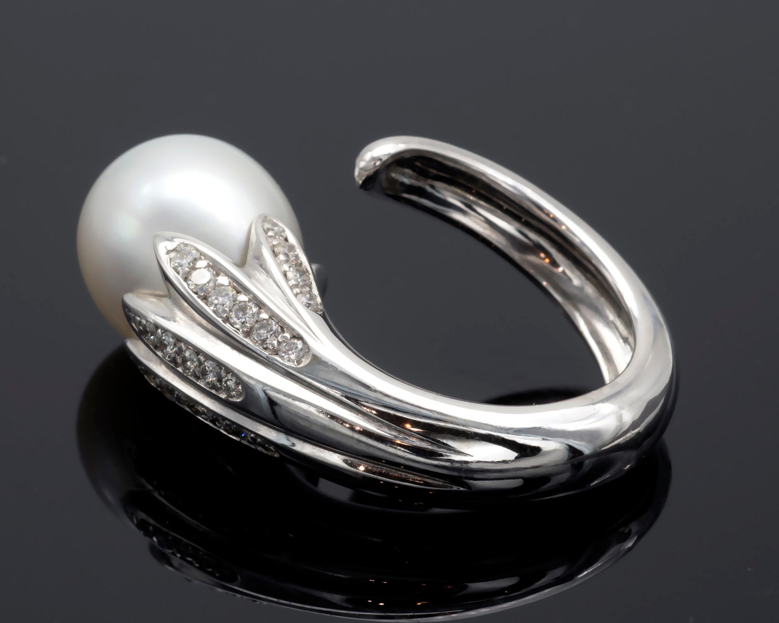 This exceptional ring showcases an 18-karat white gold shank that elegantly wraps around the finger like a stem. From this stem, leaves set with sparkling diamonds cradle a beautiful drop-shaped South Sea pearl measuring 12x16mm. The white pearl's