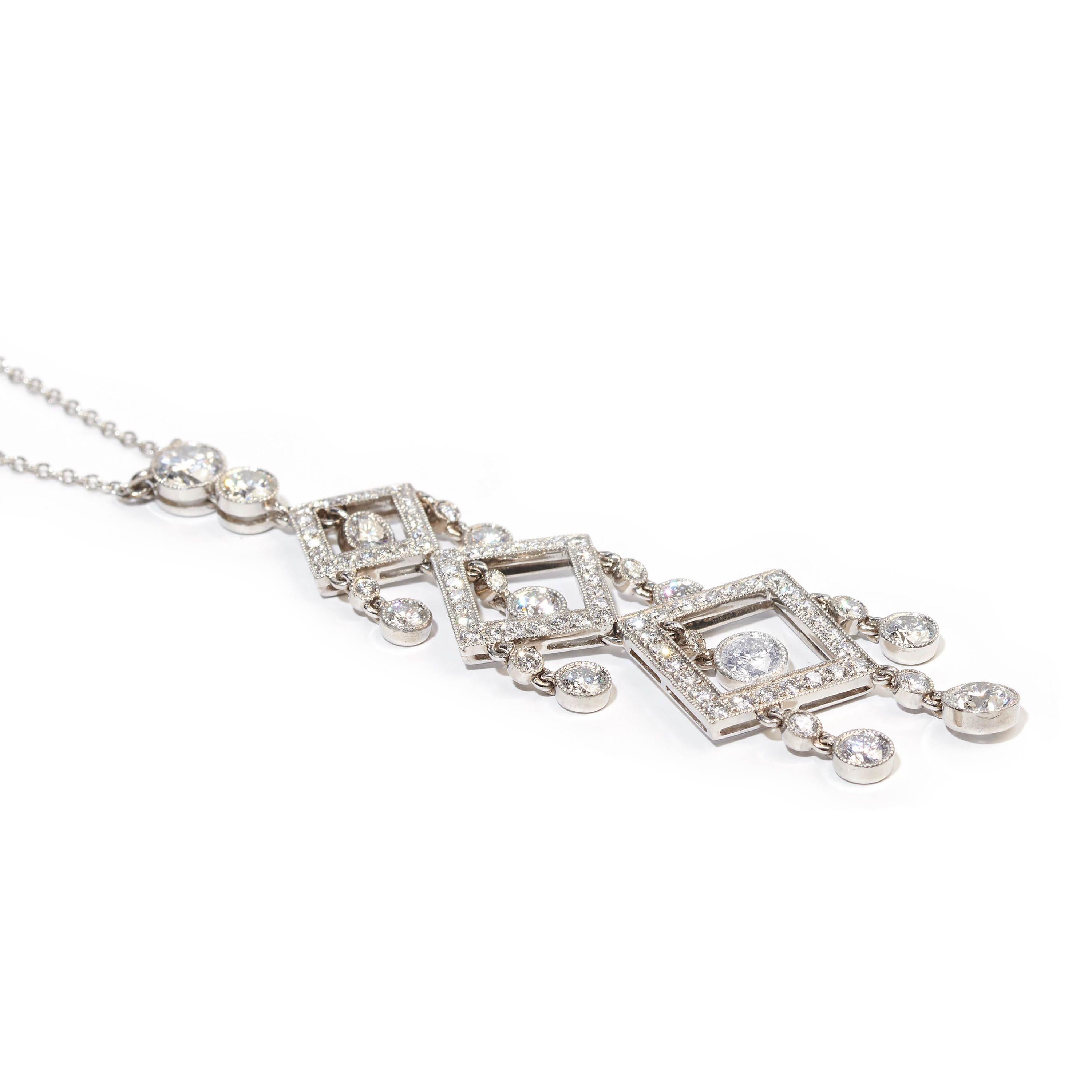 A diamond and platinum pendant, of three graduating open squares, with grain set, round brilliant-cut, diamonds, with two diamonds above and diamond drop pendants in the centre of the squares and suspending from the sides, in rub over settings, with