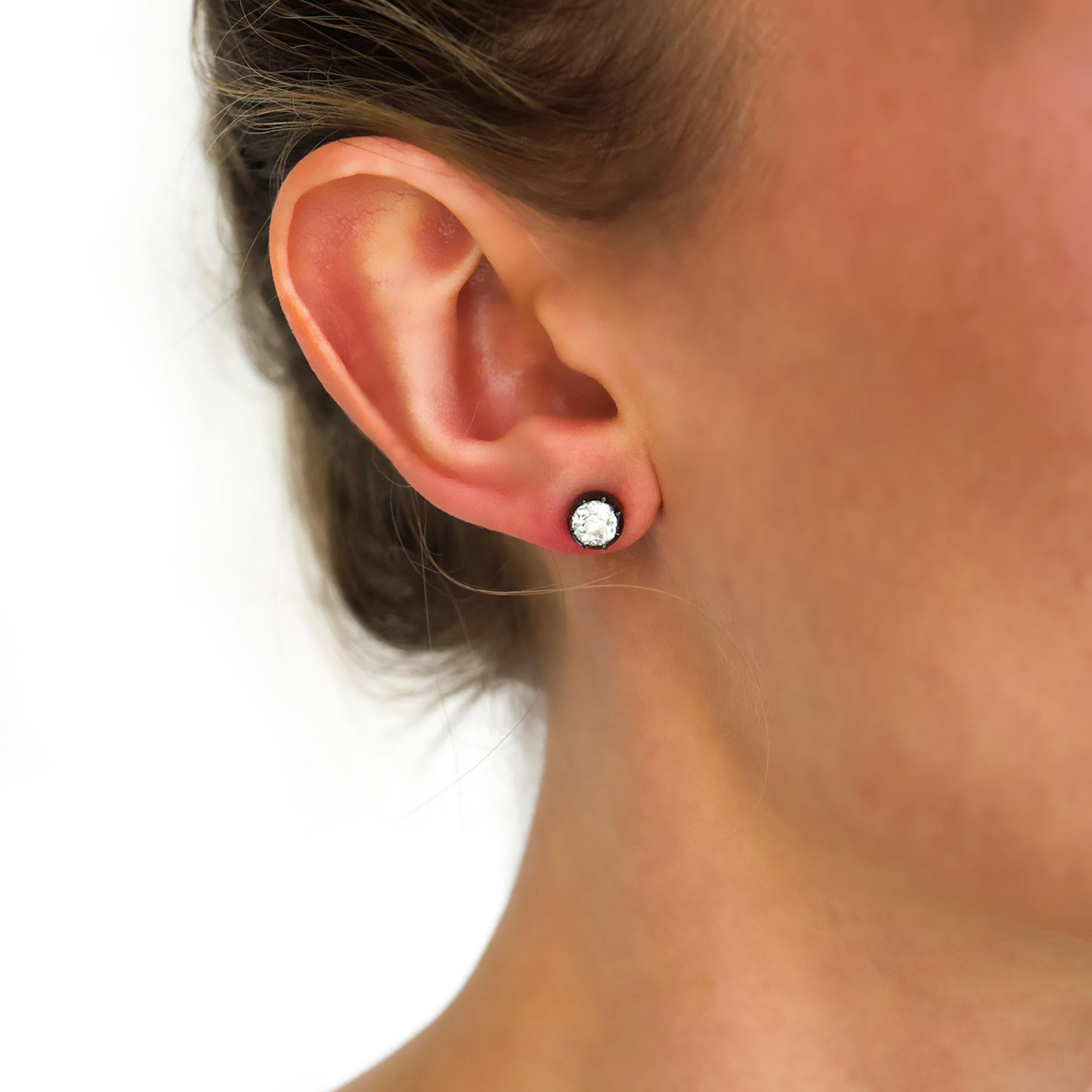 A pair of modern diamond stud earrings, each set with old-cut diamonds, in silver-upon-gold cut down settings, on gold posts, with alpha clip fittings, with a total diamond weight of 1.53 carats. In our opinion the colour is I and our opinion of the