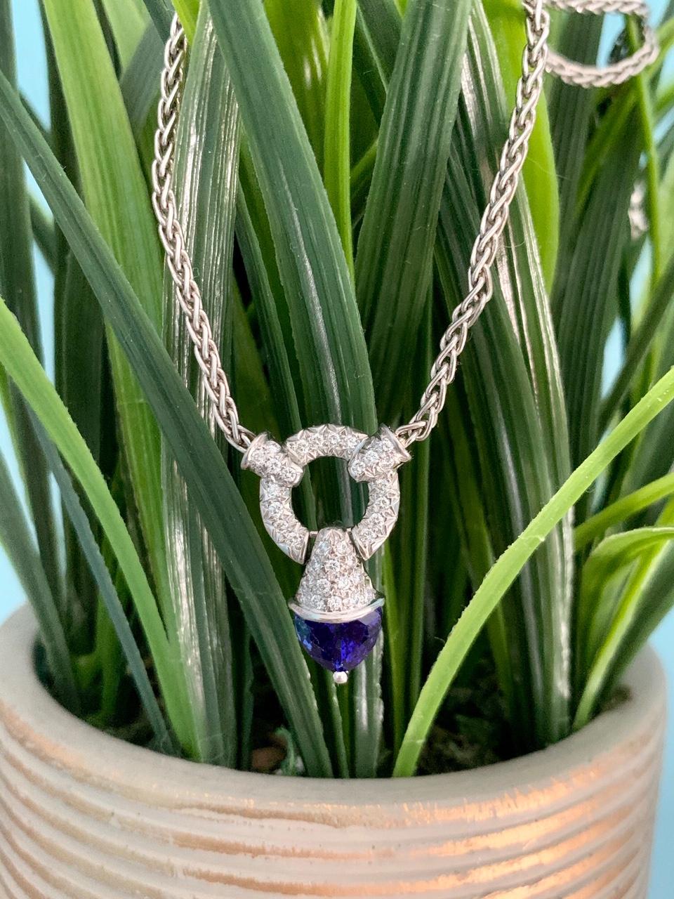 This beautiful pendant features a deep blue, gem quality, trillian cut, Tanzanite stone which measures 9 x9 x 6.85mm and weighs approximately 3.25 cts.  It is in a Platinum setting accented by 36 brilliant cut 1.6mm Diamonds, totaling approximately