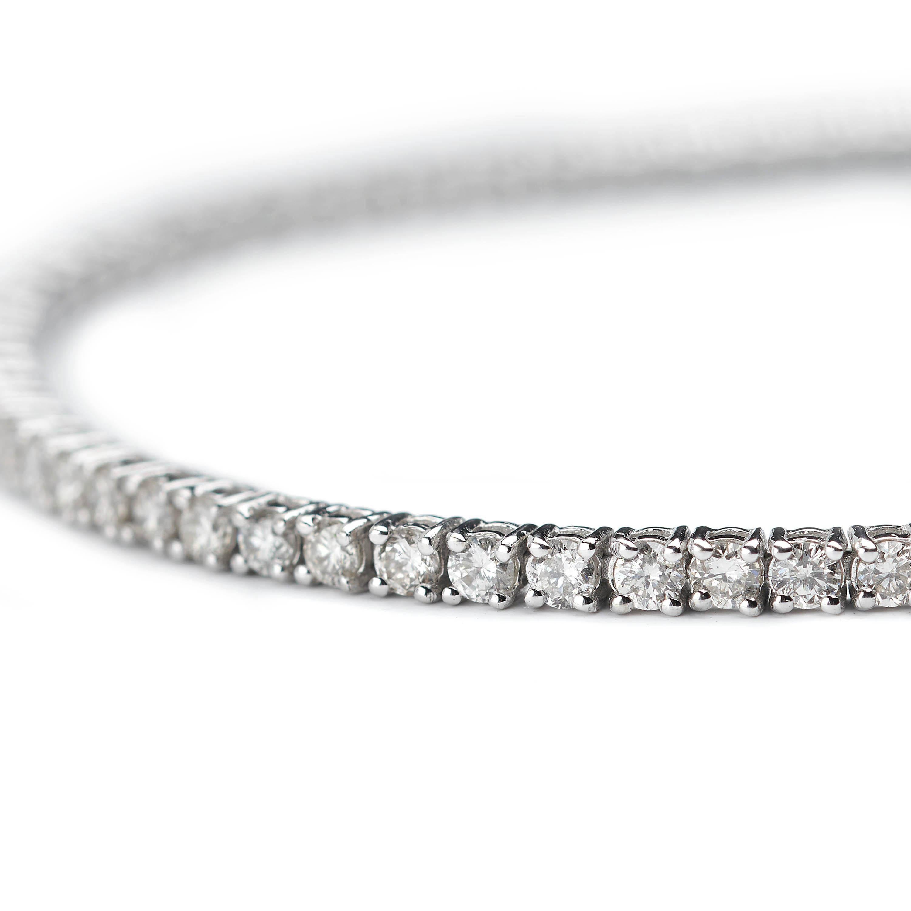 A diamond line bracelet, set with approximately 2.50ct of round brilliant-cut diamonds, in claw settings, mounted in 18ct white gold.