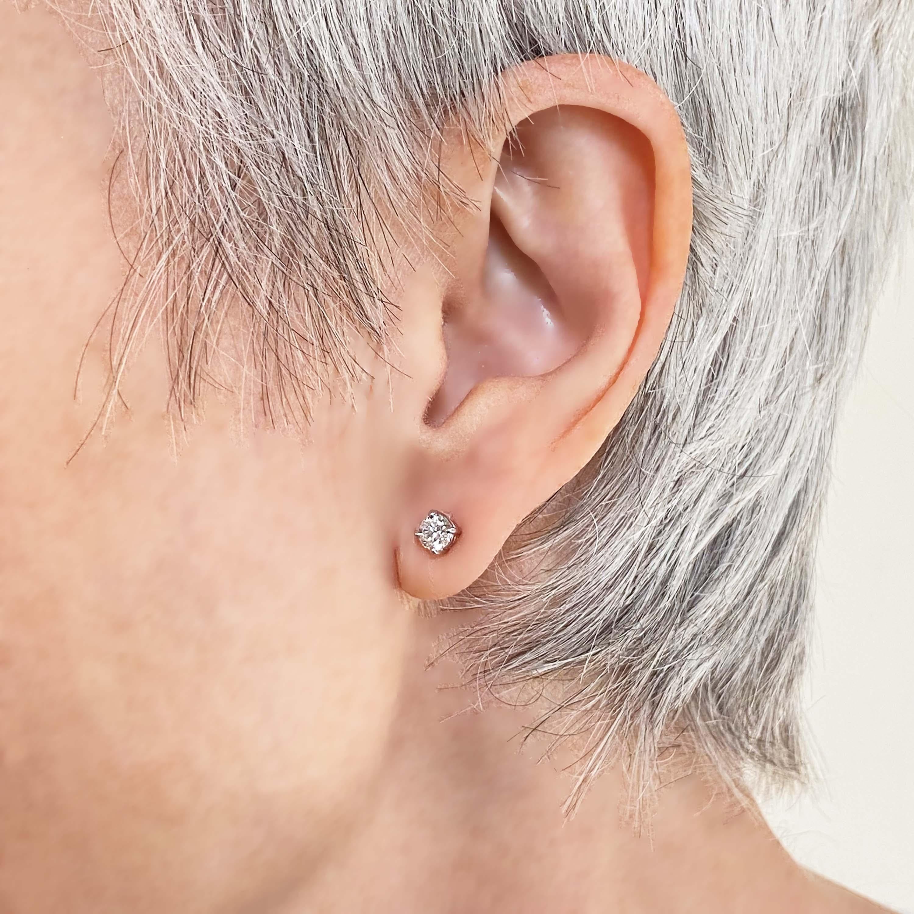 A pair of diamond ear studs, set with round brilliant-cut diamonds, with a total weight of 0.52ct, in four claw basket settings, with butterfly backs, mounted in 18ct white gold, with Sheffield Hallmarks.