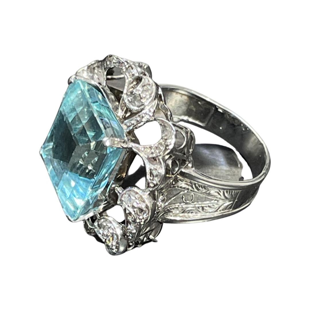 Beautiful modern diamond aquamarine ring.

Emerald cut aquamarine set in a four prong setting, surrounded by rose cut diamonds.

Make in solid 14k white gold.

Comes in size 9.

Weighs 11.21g