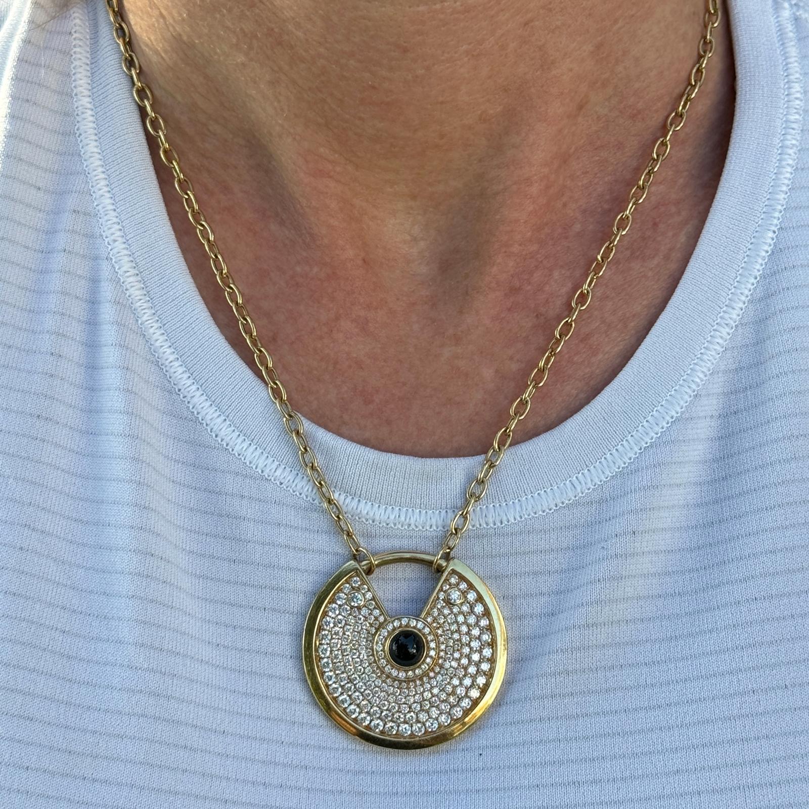 The Modern Diamond Onyx 18K Yellow Gold Amulette Pendant Necklace is a contemporary and stylish piece of jewelry that combines luxury with symbolism. The pendant features a modern interpretation of the traditional amulet or talisman, symbolizing