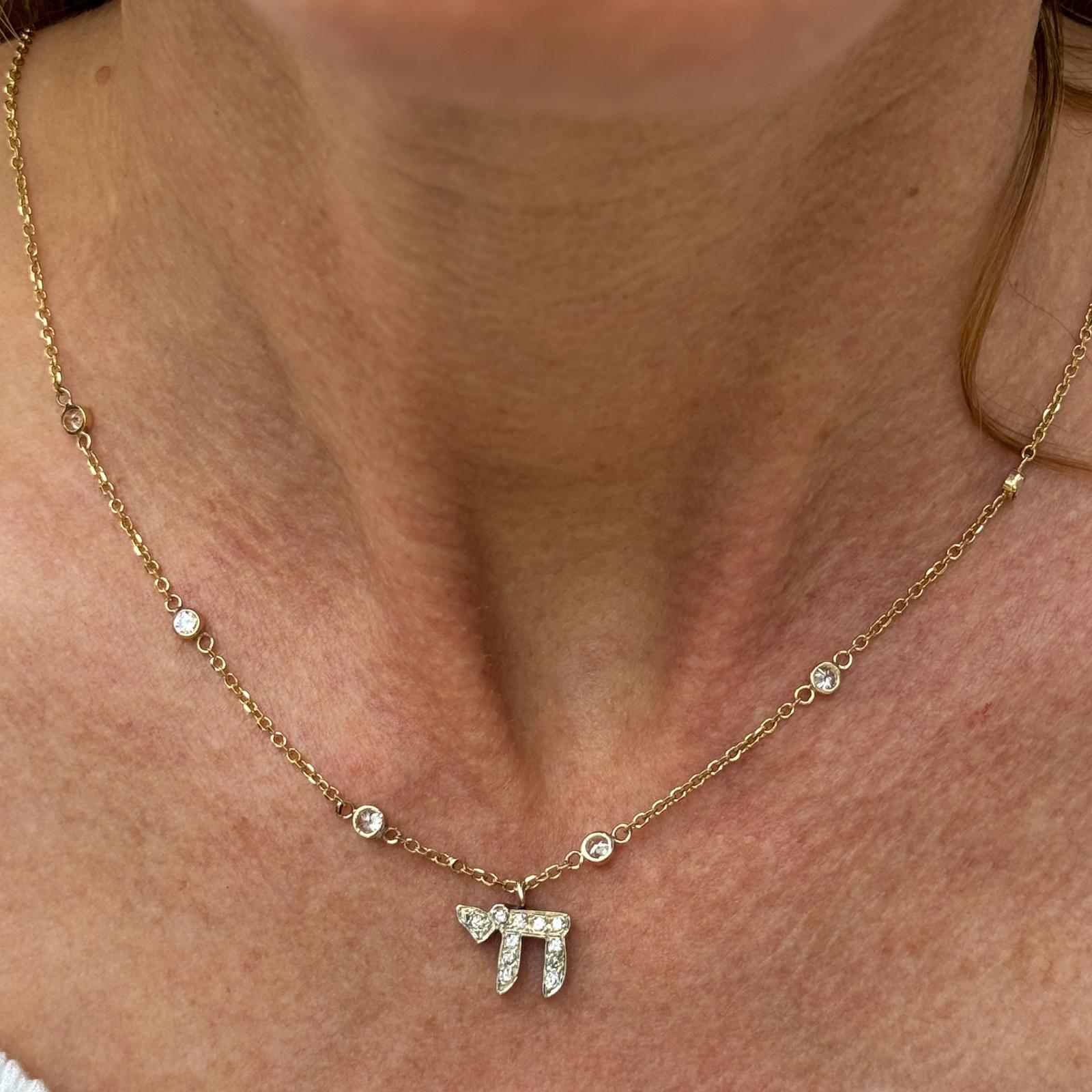 This diamond Chai pendant on a diamond by the yard necklace is a stunning and meaningful piece of jewelry that combines traditional symbolism with contemporary style.
The Chai pendant is a symbol in Jewish culture representing life, vitality, and
