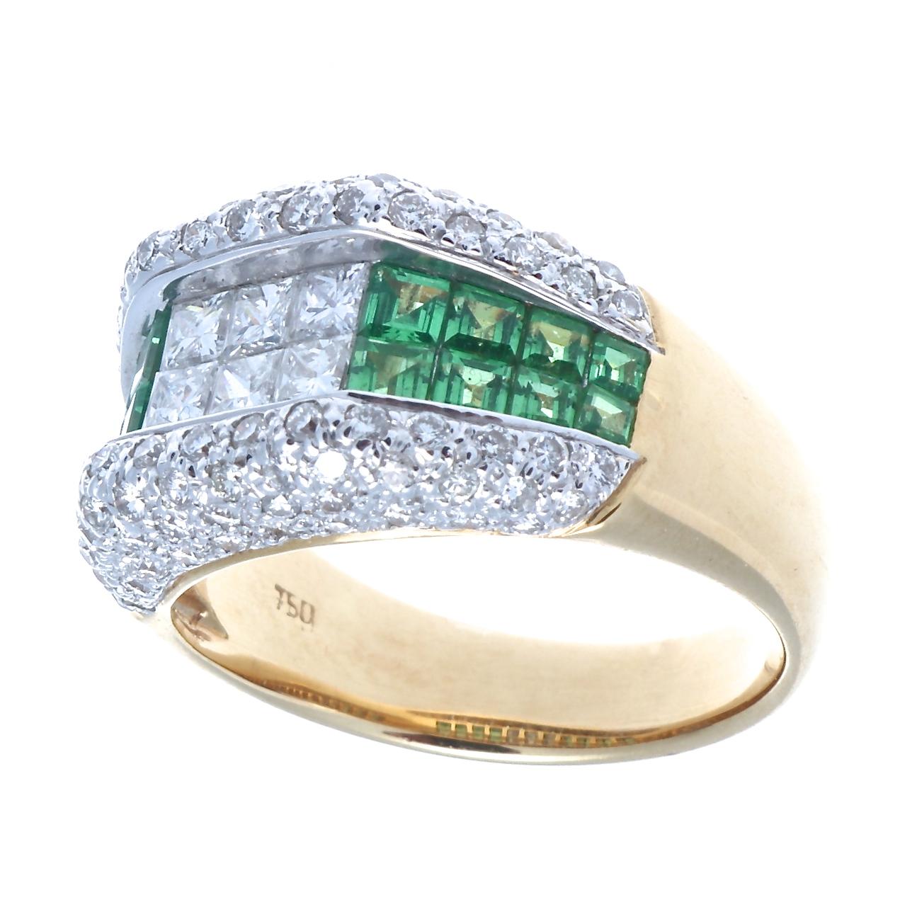 Classic modern architecture featuring color and geometric design resulting is a sparkling presentation. The ring is built with rows of near colorless diamonds and vibrant green demantoid garnets. Crafted in 18k white and yellow gold.